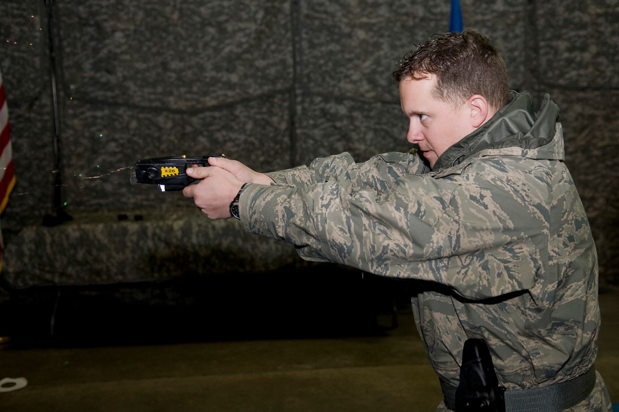 GRISSOM AIR RESERVE BASE, Ind. -- The blast doors and wires of an electronic control device can be seen as Staff Sgt. Justin Coe fires the ECD at an exercise dummy here Jan. 27. Coe, a 434th Security Forces Squadron security response team member, and other Grissom security personnel received training on such devices that they will begin carrying on-duty no later than April 1. (U.S. Air Force photo/Tech. Sgt. Mark R. W. Orders-Woempner) 
