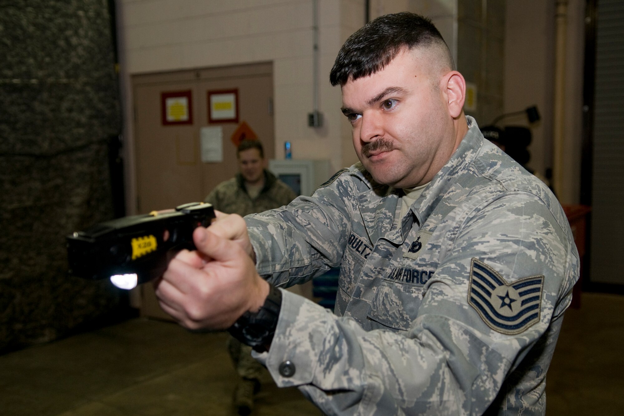 GRISSOM AIR RESERVE BASE, Ind. -- Tech. Sgt. Adam Soultz, a 434th Security Forces Squadron security response team leader, prepares to fire an electronic control device during a training exercise here Jan. 27. All 434th SFS members who could carry an ECD as part of their duty were trained on the devices, which will be worn by Grissom's on-duty security force officers no later than April 1. (U.S. Air Force photo/Tech. Sgt. Mark R. W. Orders-Woempner) 
