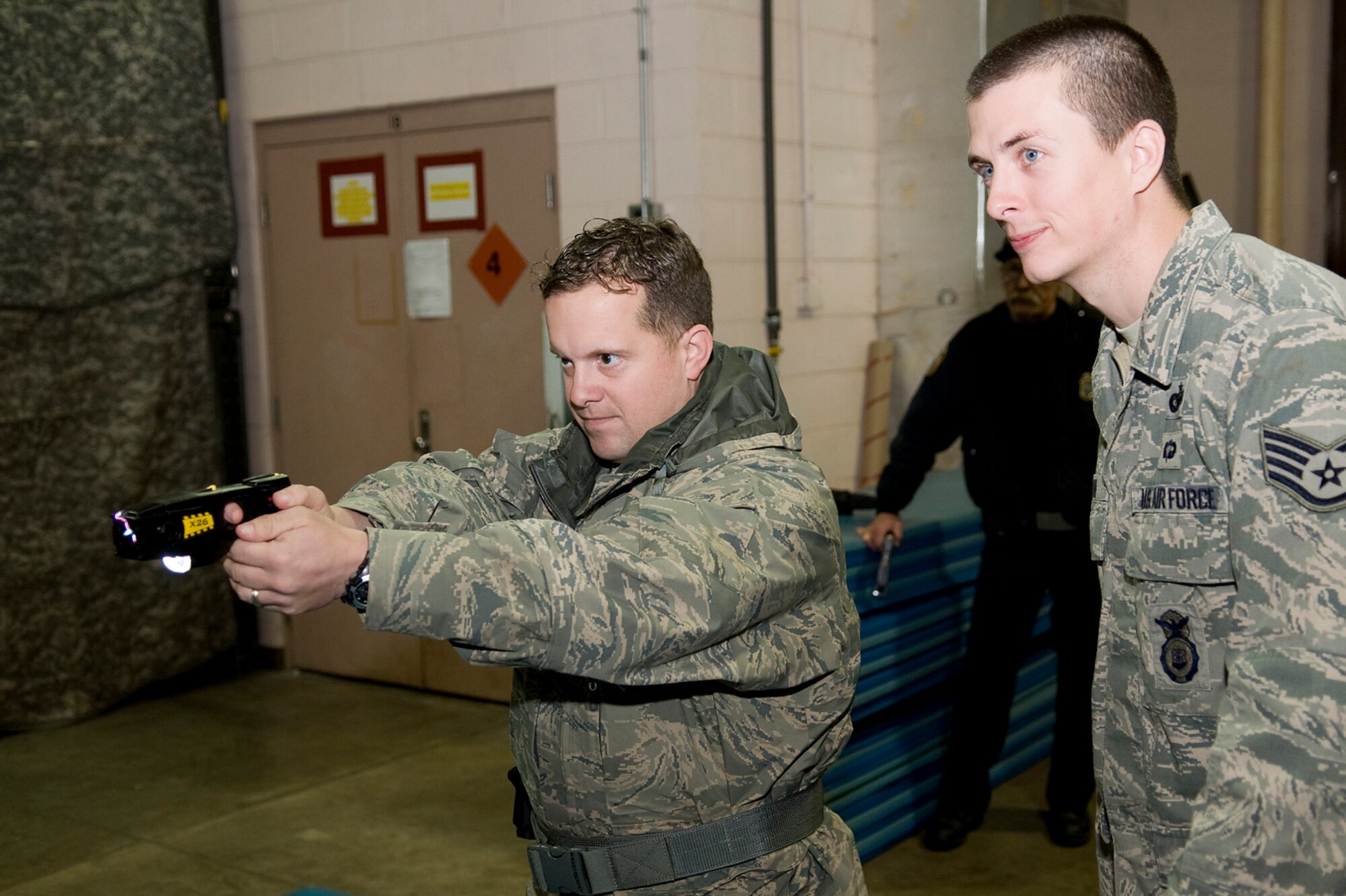 GRISSOM AIR RESERVE BASE, Ind. -- Staff Sgt. Justin Coe, a 434th Security Forces Squadron security response team member, fires an electronic control device during a training exercise Jan. 27 as Staff Sgt. Dustin Devine evaluates his performance. Devine trained all 434th SFS members who will use ECDs, which will be worn by Grissom's on-duty security force officers no later than April 1. (U.S. Air Force photo/Tech. Sgt. Mark R. W. Orders-Woempner) 

