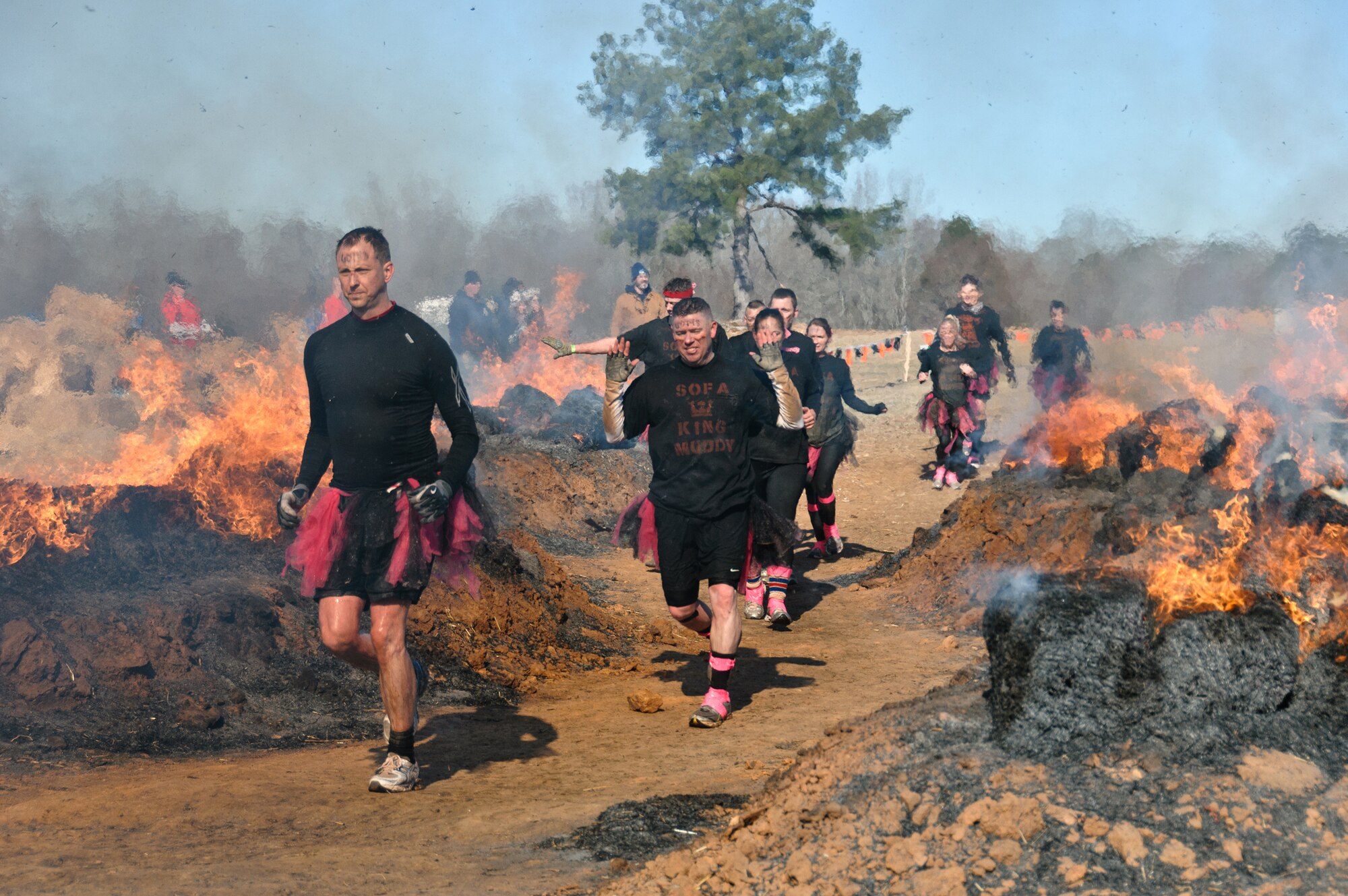 From left: Master Sgt. Paul Flipse, Headquarters Air Force Reserve Command Recruiting Squadron public affairs; Staff Sgt. Jonathan Galvin, an Air Force Reserve Line Recruiter with the HQ AFRC RS; and the rest of the team run around burning bales of hay during the Tough Mudder event Feb. 12, 2012, in Washington, Ga. The fire was a welcomed treat after swimming through near-freezing water. The team comprised Airmen from Robins Air Force Base, Ga., and Eglin AFB, Fla. (U.S. Air Force photo/Staff Sgt. Alexy Saltekoff)