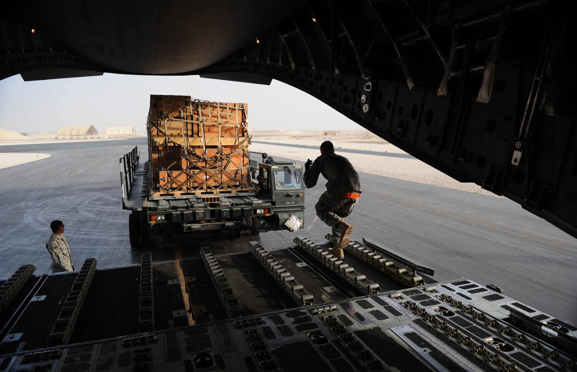 SOUTHWEST ASIA – Airman 1st Class Michael Bethell directs a 60k loader to the back of a C-17 Globemaster III here Feb. 11, 2012. Airmen from the 8th EAMS ramp section, which is responsible for loading and unloading cargo on aircraft, work with the aircraft’s loadmasters to get the cargo loaded. (U.S. Air Force photo/Staff Sgt. Nathanael Callon)