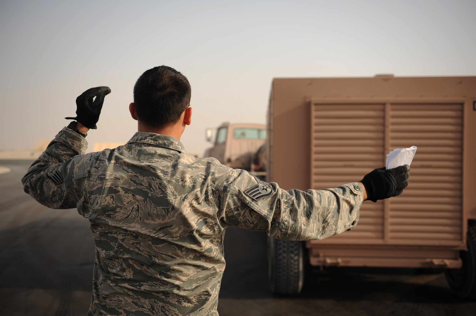 SOUTHWEST ASIA – Staff Sgt. Walter Towers, 8th Expeditionary Air Mobility Squadron ramp supervisor and native of Vega Baja, Puerto Rico, directs a vehicle operator backing up a generator prior to loading in a C-17 Globemaster III here Feb. 11, 2012. Airmen from the 8th EAMS ramp section are trained to load all types of cargo onto aircraft. (U.S. Air Force photo/Staff Sgt. Nathanael Callon)