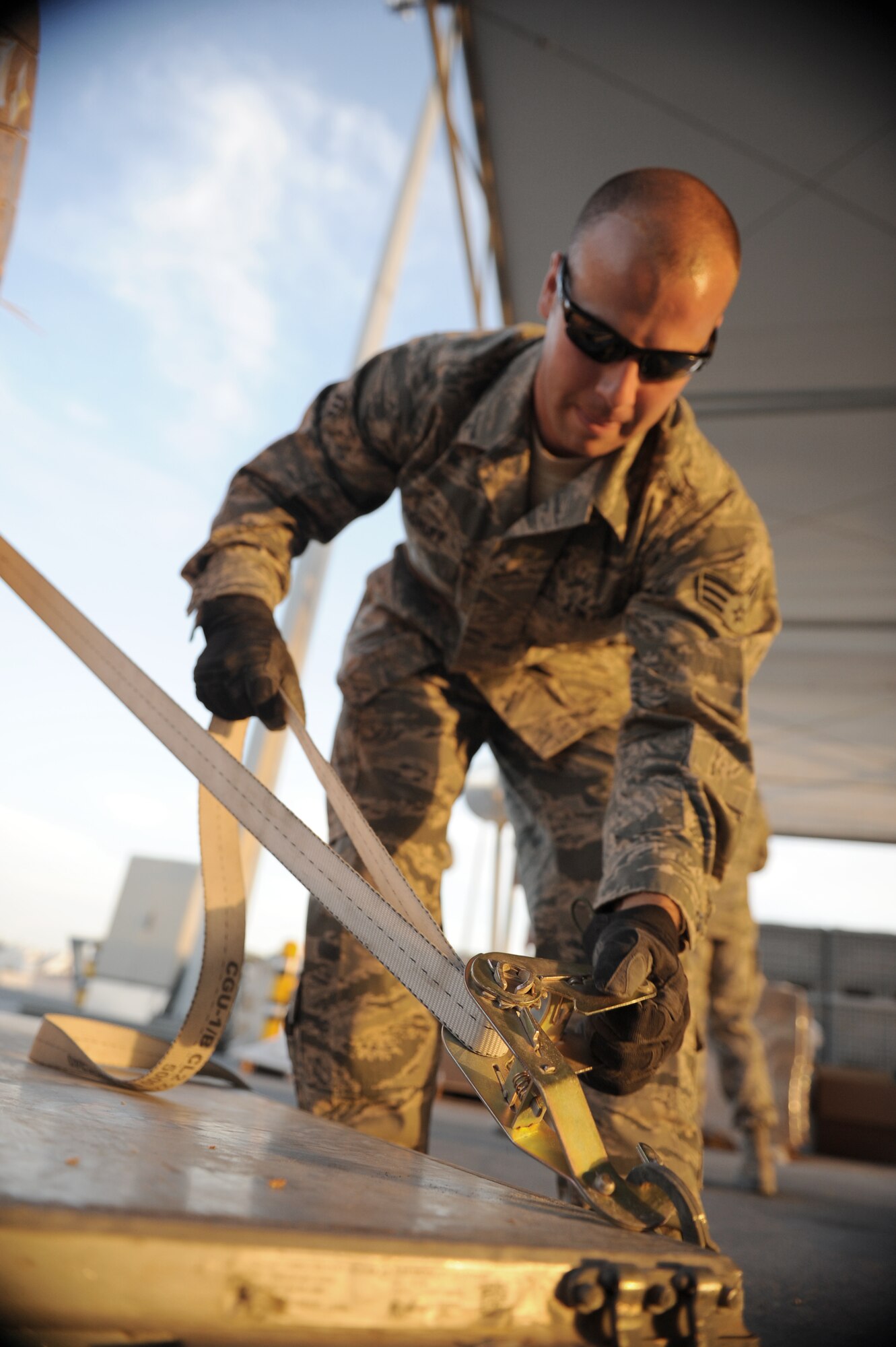 SOUTHWEST ASIA – Senior Airman Jonathan Woodruff, 8th Expeditionary Air Mobility Squadron air transportation specialist and native of Griffin, Ga., secures a pallet of copper wire here Feb. 10, 2012. The cargo processing section receives orders from the load planning section and prepares the materials for transport from the cargo yard to the plane. (U.S. Air Force photo/Staff Sgt. Nathanael Callon)