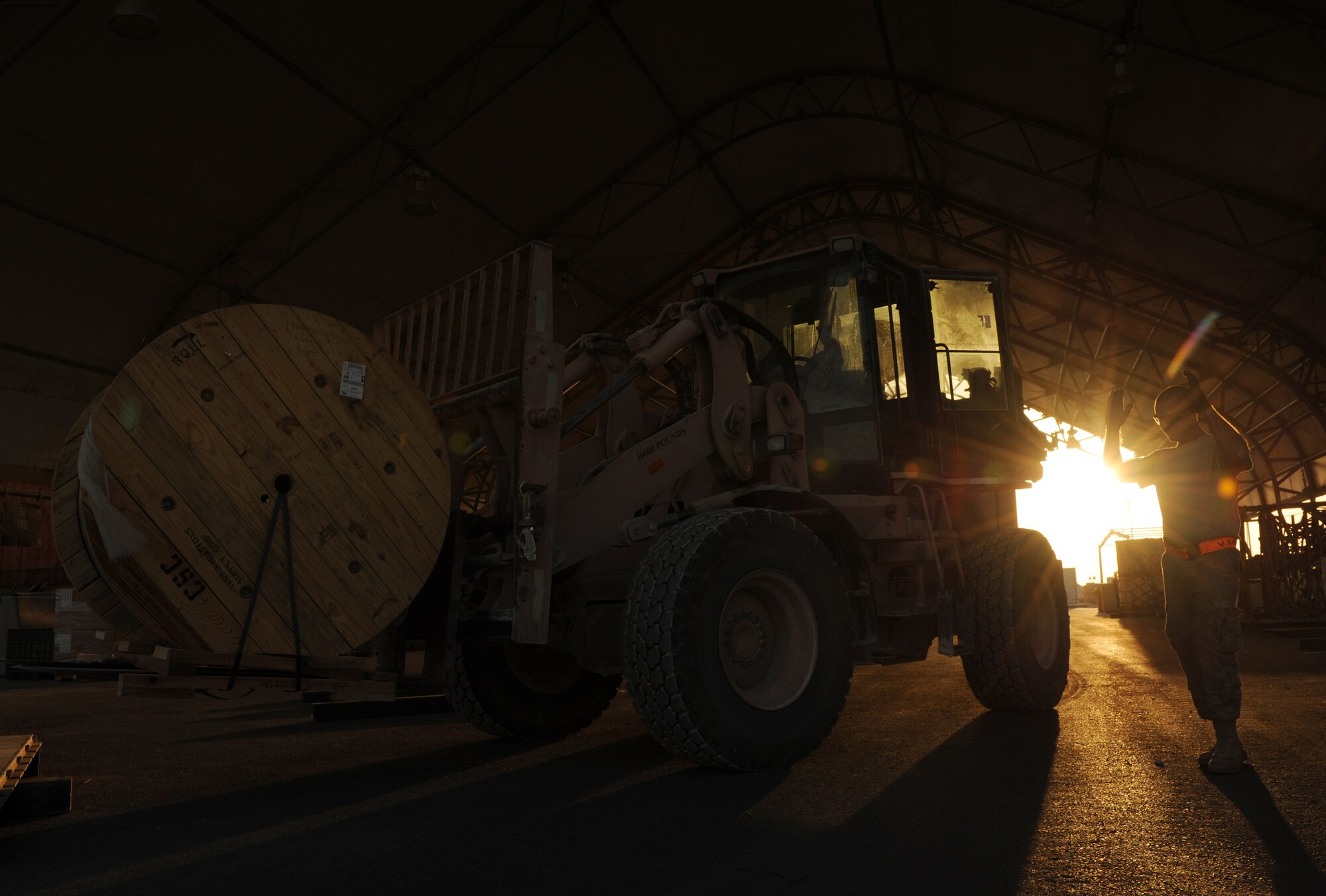 SOUTHWEST ASIA – Airmen from the 8th Expeditionary Air Mobility Squadron Cargo Processing Section move a roll of copper wire to a pallet here Feb. 10, 2012. The cargo processing section receives orders from the load planning section and prepares the materials for transport from the cargo yard to the plane. (U.S. Air Force photo/Staff Sgt. Nathanael Callon)