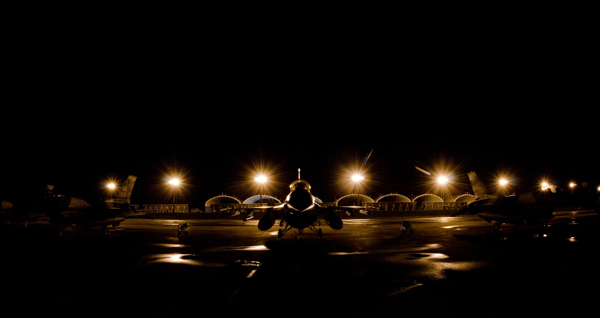 ERSEN AIR FORCE BASE, Guam - F-16 Aircraft from 18th Aggressor Squadron, Eielson Air Force Base, Alaska are parked in the early morning during Cope North 2012 Feb. 15. The 18 AS is here in support of Cope North 2012, flying as the opposing force to the other aircraft participating in the Exercise. Exercise Cope North 2012, a three-week exercise between the U.S. Air Force, the Japan Air Self Defense Force and the Royal Australian Air Force, began Feb. 11 here bringing more than 1,000 service members to the island. The exercise, which will run through Feb. 24, is designed to enhance air operations and serve as a reminder of the three nations are commitment to preserving peace in the Pacific area of responsibility. (U.S Air Force photo by Staff Sgt. Alexandre Montes)