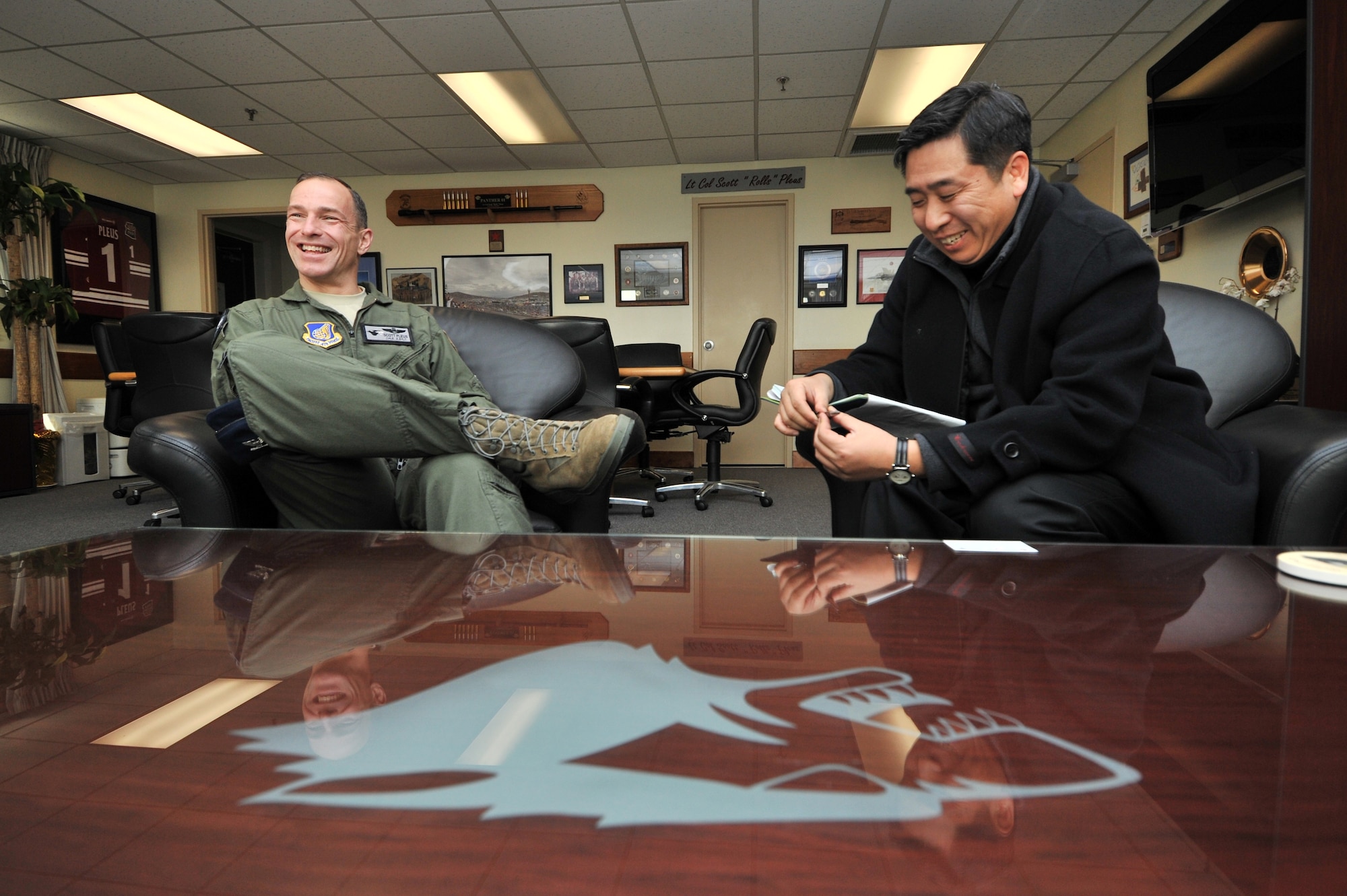 Sung-Bum An, Defense Times Korea chief editor, interviews Col. Scott Pleus, 8th Fighter Wing commander, during a base tour at Kunsan Air Base, Republic of Korea, Feb. 10, 2012. Kunsan Airmen will be featured in the March issue of Defense Times Korea. (U.S. Air Force photo by Senior Airman Brittany Y. Auld/Released)