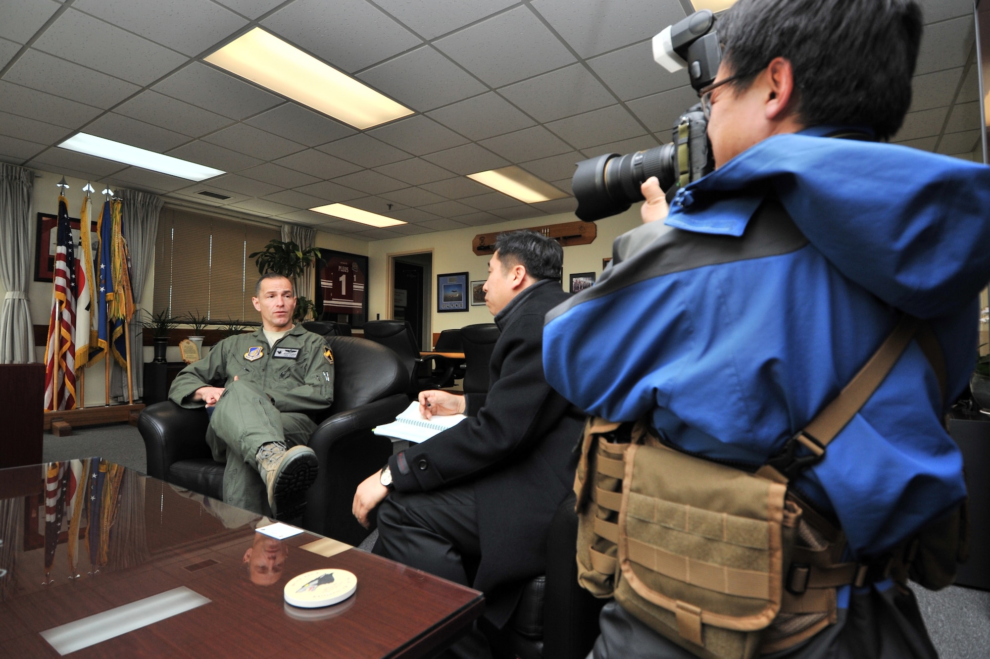 Photojournalists from the Defense Times Korea, interviewed Col. Scott Pleus, 8th Fighter Wing commander during a base tour at Kunsan Air Base, Republic of Korea, Feb. 10, 2012. Kunsan Airmen will be featured in the March issue of Defense Times Korea. (U.S. Air Force photo by Senior Airman Brittany Y. Auld/Released)