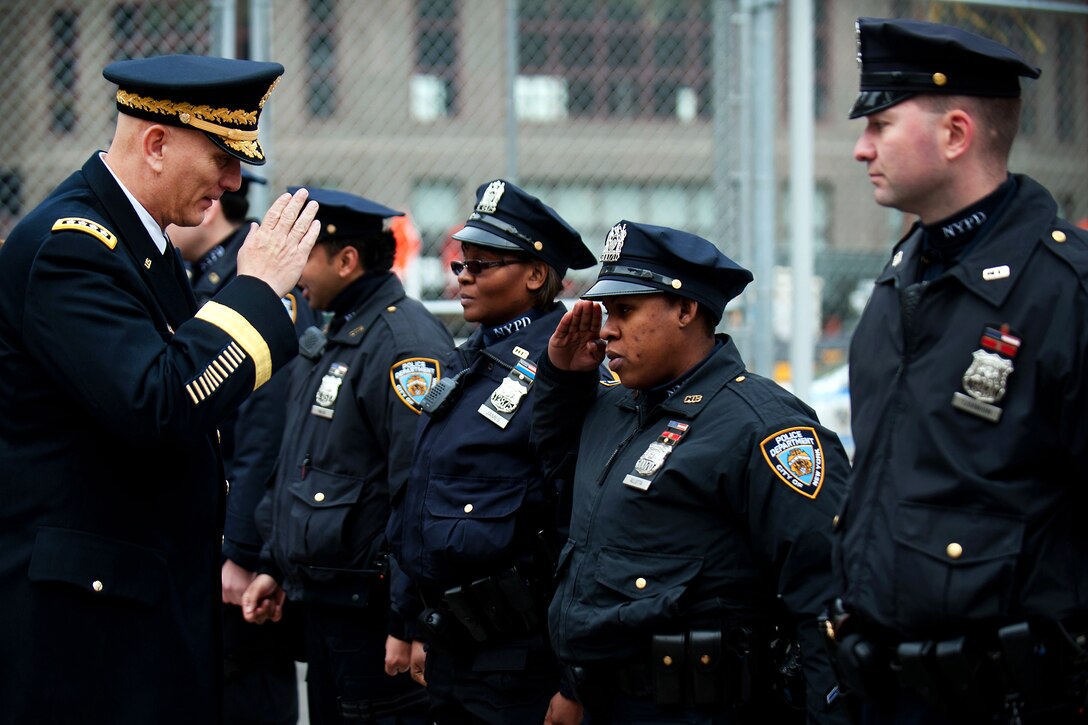 A New York police officer salutes Army Chief of Staff Gen. Raymond T. Odierno during a visit to the 9/11 Memorial in New York, Feb. 14, 2012. The 9/11 Memorial is a national tribute of remembrance and honor to the men, women and children killed in the terrorist attacks of Sept. 11, 2001, and Feb. 26, 1993.