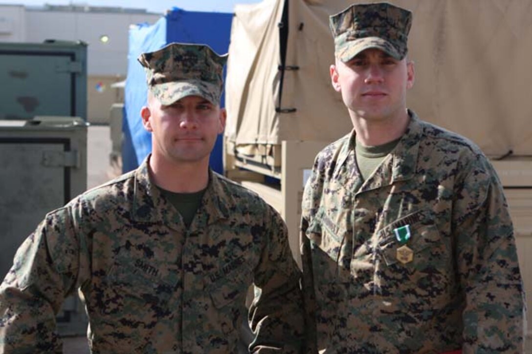 Sgt. Jeremy W. Caddell, right, the Marine Wing Communication Squadron 38 deputy family readiness officer and Web City, Mo., native, stands with Gunnery Sgt. David W. Smith, left, the training chief of H&S Bn., MCRD San Diego and Star, Texas, native, after Caddell was awarded the Navy and Marine Corps Commendation Medal Feb. 15. Caddell was a key contributor in saving Smith™s life after Smith was the victim of a hit-and-run accident on his motorcycle in Rancho Bernardo.