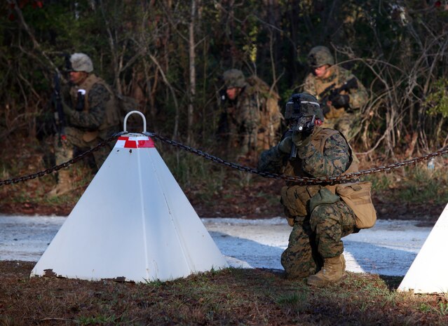 A Marine with Battalion Landing Team 1st Battalion, 2nd Marine Regiment, 24th Marine Expeditionary Unit, suppresses the enemy as Marines cross the street to assault an enemy encampment during a training raid at Camp Lejeune’s Military Operations in Urban Terrain compound, Feb. 14, 2012. This raid was the final mission for the 24th MEU’s Certification Exercise (CERTEX) with Iwo Jima Amphibious Ready Group, which took place Jan. 27 to Feb. 16, and included a series of missions intended to evaluate and certify the unit for their upcoming deployment.
