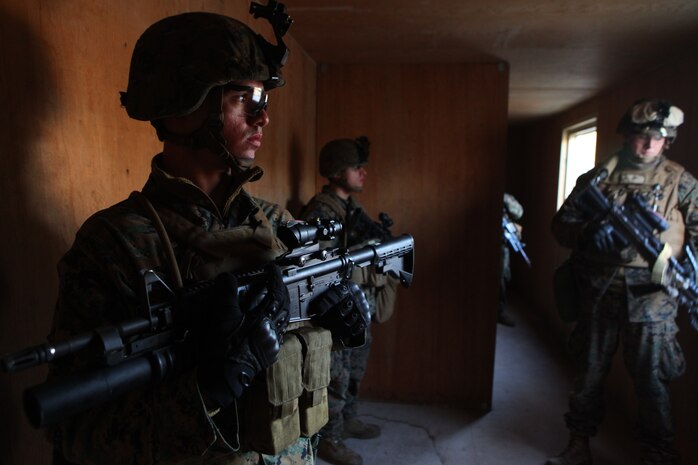 Marines with Charlie Company, Battalion Landing Team 1st Battalion, 2nd Marine Regiment, 24th Marine Expeditionary Unit, secure a building so other Marines can advance during a training raid at Camp Lejeune’s Military Operations in Urban Terrain Compound, Feb. 15. The raid was part of Certification Exercise (CERTEX) - the final at-sea training exercise for the 24th MEU with the Iwo Jima Amphibious Ready Group which took place Jan. 27-Feb. 16, and included a series of missions intended to evaluate and certify the units for their upcoming deployment.