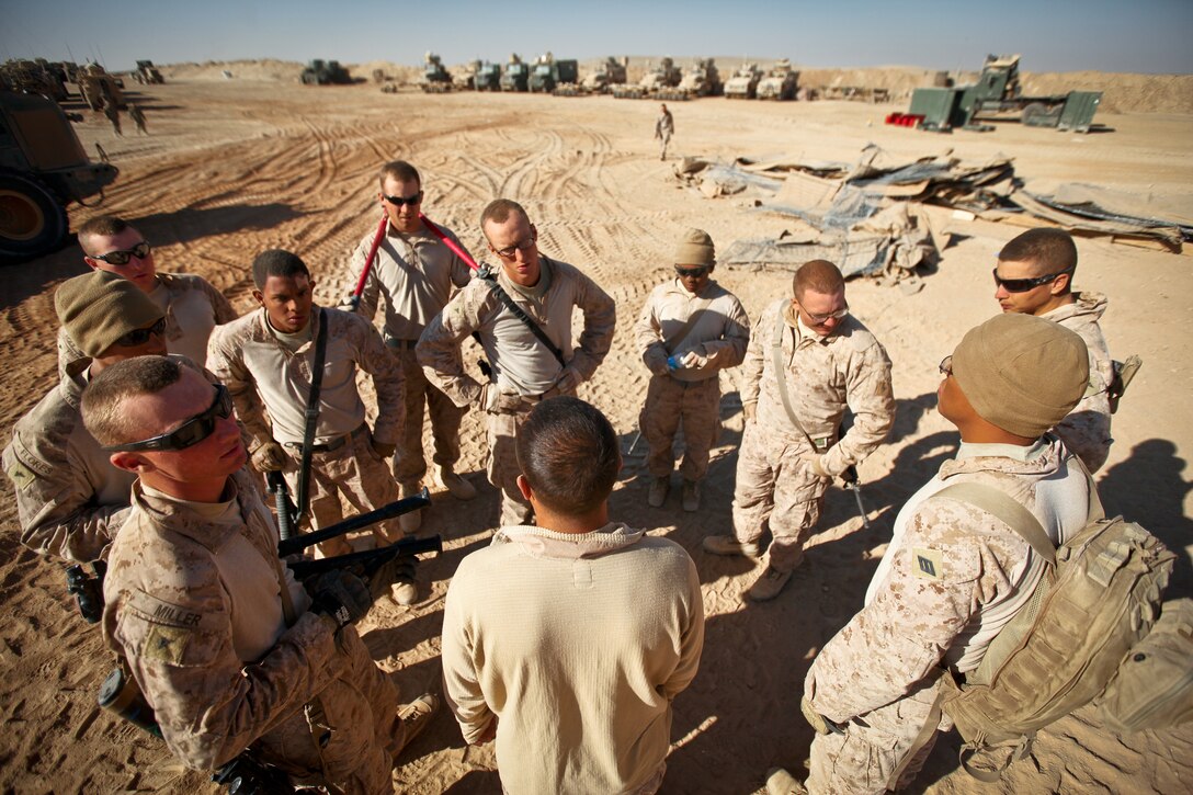 Cpl. James Hernandez, a combat engineer with Alpha Company, 9th Engineer Support Battalion, and a native of Goodyear, Ariz., offers a word of encouragement and motivation to the Marines under his charge at Firebase Saenz, Helmand province, Dec. 14. FB Saenz is the first of several patrol bases being demilitarized by the Marines of 9th ESB throughout the month of December.