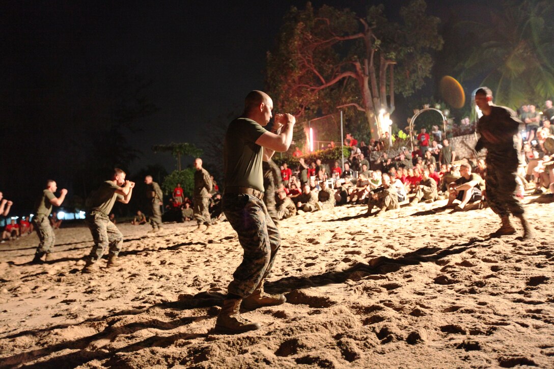 Staff Sgt. James P. Conway, weapons platoon sergeant, Company B, Battalion Landing Team 1st Battalion, 4th Marines, 31st Marine Expeditionary Unit (foreground) prepares to demonstrate the Marine Corps Martial Arts Program to gathered Royal Thai and U.S. Marines, as part of a sports day and warrior dinner celebration of camaraderie on the beach here, Feb. 16. The celebration was held to highlight the successes of the bilateral military forces which participated in Cobra Gold 2012.  Cobra Gold 2012 demonstrates the resolve of the U.S. and participating nations to increase interoperability and promote security and peace throughout the Asia-Pacific region. The 31st MEU is the only continuously forward-deployed MEU and remains the U.S.'s force in readiness in the Asia-Pacific region.