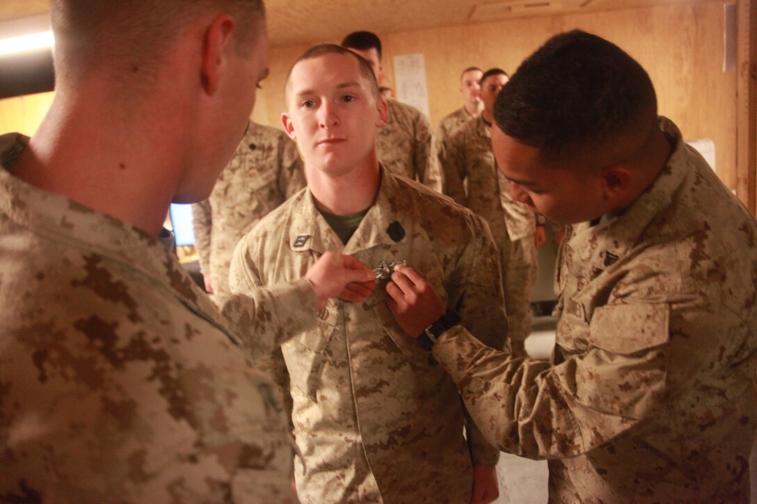 Seaman Chase Lapradd, a corpsman attached to 2nd Marine Aircraft Wing (Forward), and a native of Drakes Branch, Va., receives his Fleet Marine Force qualification at Camp Leatherneck, Afghanistan, Feb. 16. The Fleet Marine Force qualification is issued to Sailors who are trained and qualified to perform duties in support of U.S. Marine Corps operations, and can only be issued by Marine commanding generals or commanding officers of regimental-level commands. More than 50 Sailors attached to 2nd Marine Aircraft Wing (Forward) have earned the qualification in the past year.