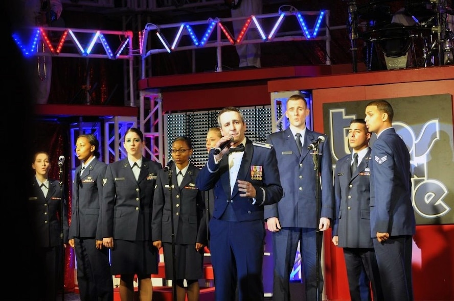 Senior Airman Robin Elrod, 303rd Intelligence Squadron and Maj. Christopher Burch, former Tops in Blue cast member, perform with other contestants at the 2012 Air Force talent search competition banquet at Lackland Air Force Base, Texas, Jan. 9 - 16. (U. S Air Force photo)