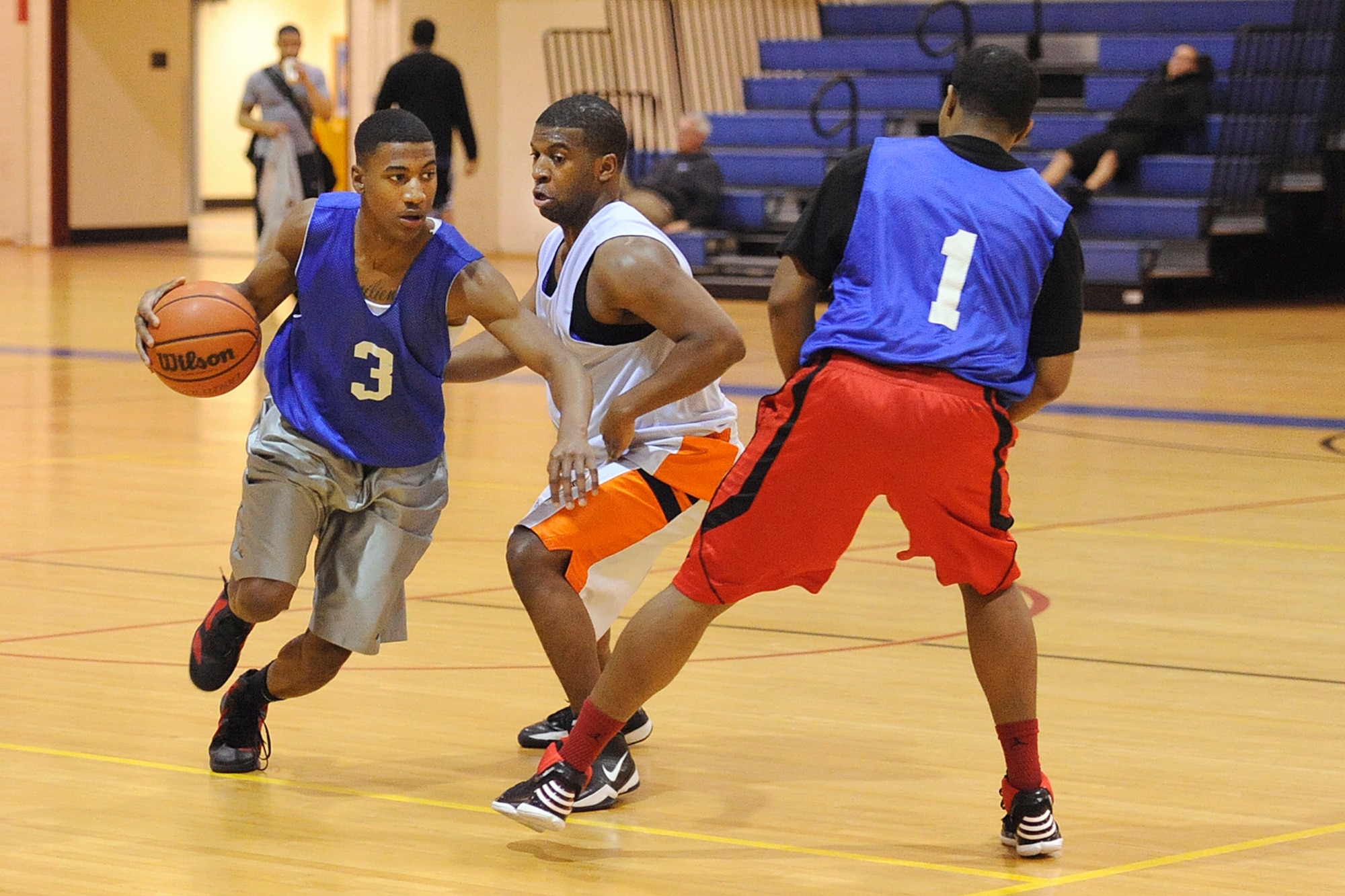 Kenneth Brandon drives against the 3rdMXS defense in the third place gameMonday night at the JBER-E Fitness Center. (U.S. Air Force photo/John Pennell)