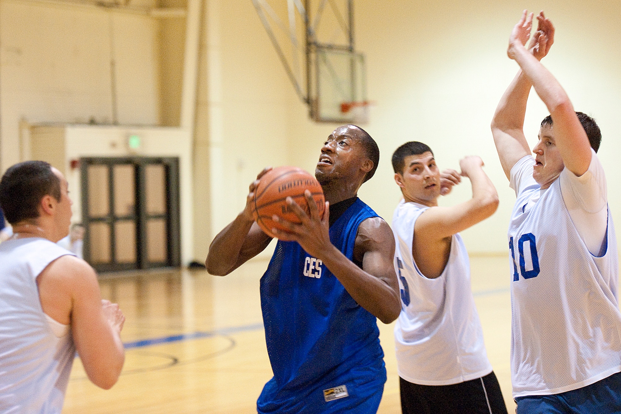 Arnold Cochran, 773rd CES, weaves his way through the 3rd MXS defense in the championship game Monday night at the JBER-E Fitness Center. Cochran and his CES teammates defeated the 3rd MXS team, 66-59. (U.S. Air Force photo/John Pennell)