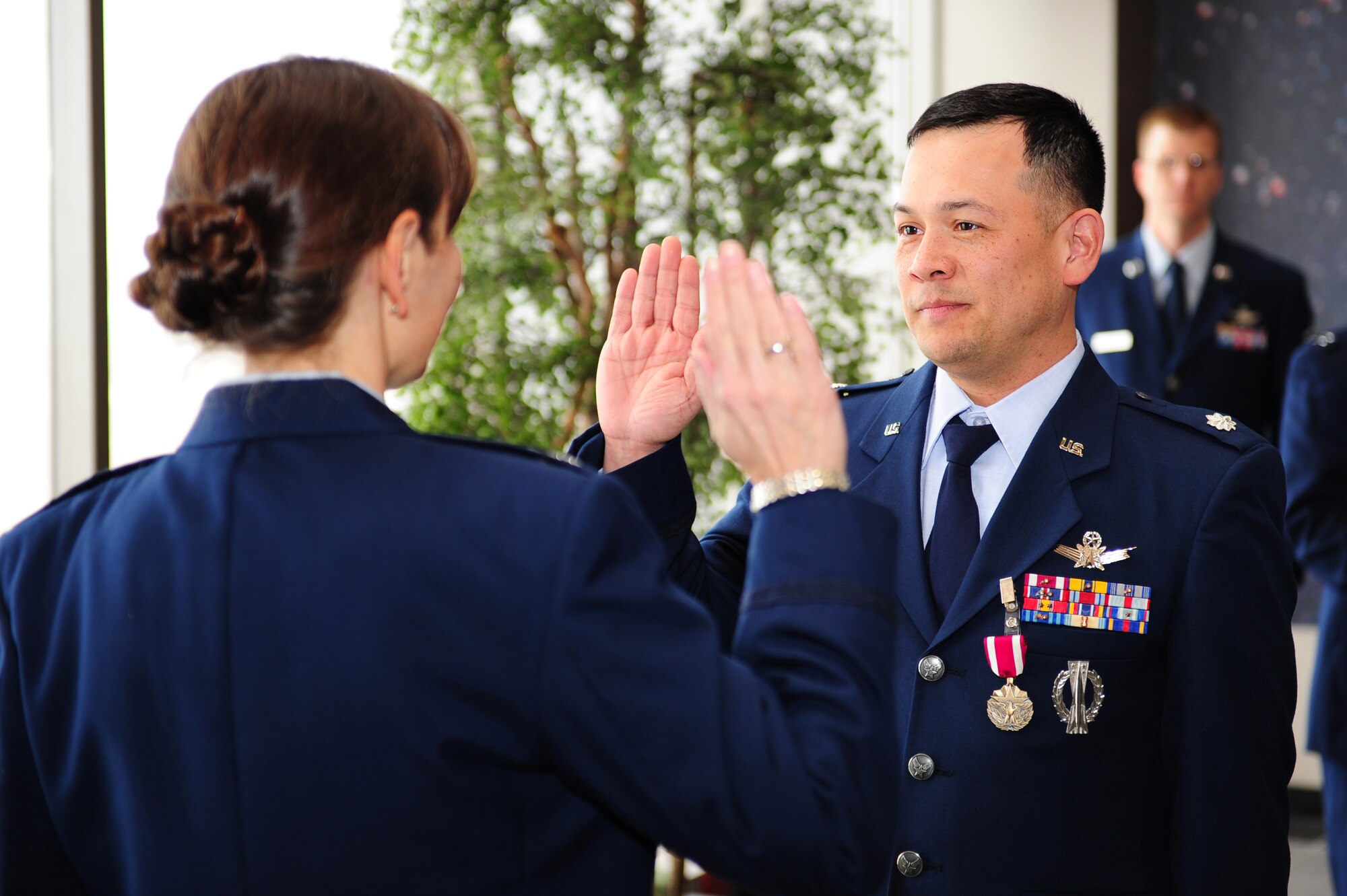 Lt. Col. Jason King recites the oath of office at his promotion ceremony officiated by Lt. Col. Traci Kueker-Murphy, 310th Space Wing Operations Group commander at Schriever Air Force Base, Colo., January 12. Lt. Col. King is the Chief of The 310 OG/OGV. (U.S. Air Force photo/Tech. Sgt. Nicholas B. Ontiveros).