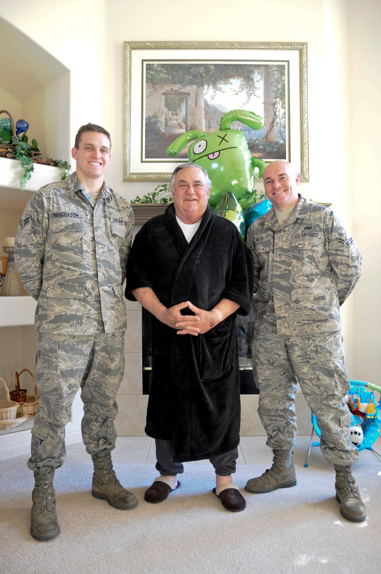 Airmen 1st Class David Hutchason and Tod Miley, both members of the 144th Maintenance Group, California Air National Guard, stand beside retired Chief Master Sgt. Lawrence Pollastrini (center) on Feb. 5, 2012.  Their meeting comes one week after Chief Pollastrini suffered a heart attack and Airmen Hutchason and Miley saved his life by administering CPR.  (Air National Guard photo by Tech. Sgt. Charles Vaughn)