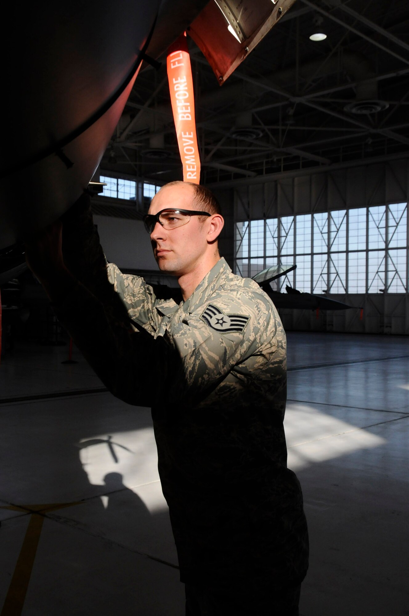 Staff Sgt. Scott Calhoun, an avionics specialist with the 144th Maintenance Group, California Air National Guard, troubleshoots the F-16 Fighting Falcon electronics on January 13, 2012.  (Air National Guard photo by Tech. Sgt. Charles Vaughn)