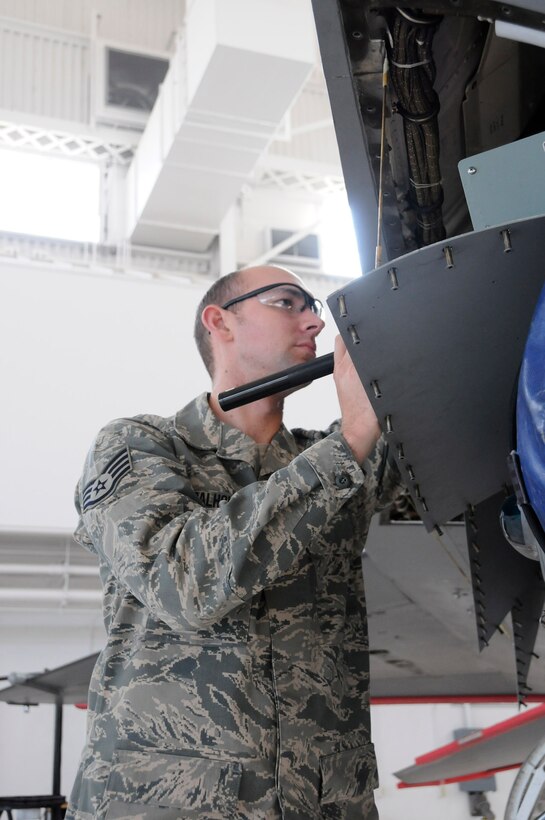 Staff Sgt. Scott Calhoun, an avionics specialist with the 144th Maintenance Group, California Air National Guard, troubleshoots the F-16 Fighting Falcon electronics on January 13, 2012.  (Air National Guard photo by Tech. Sgt. Charles Vaughn)