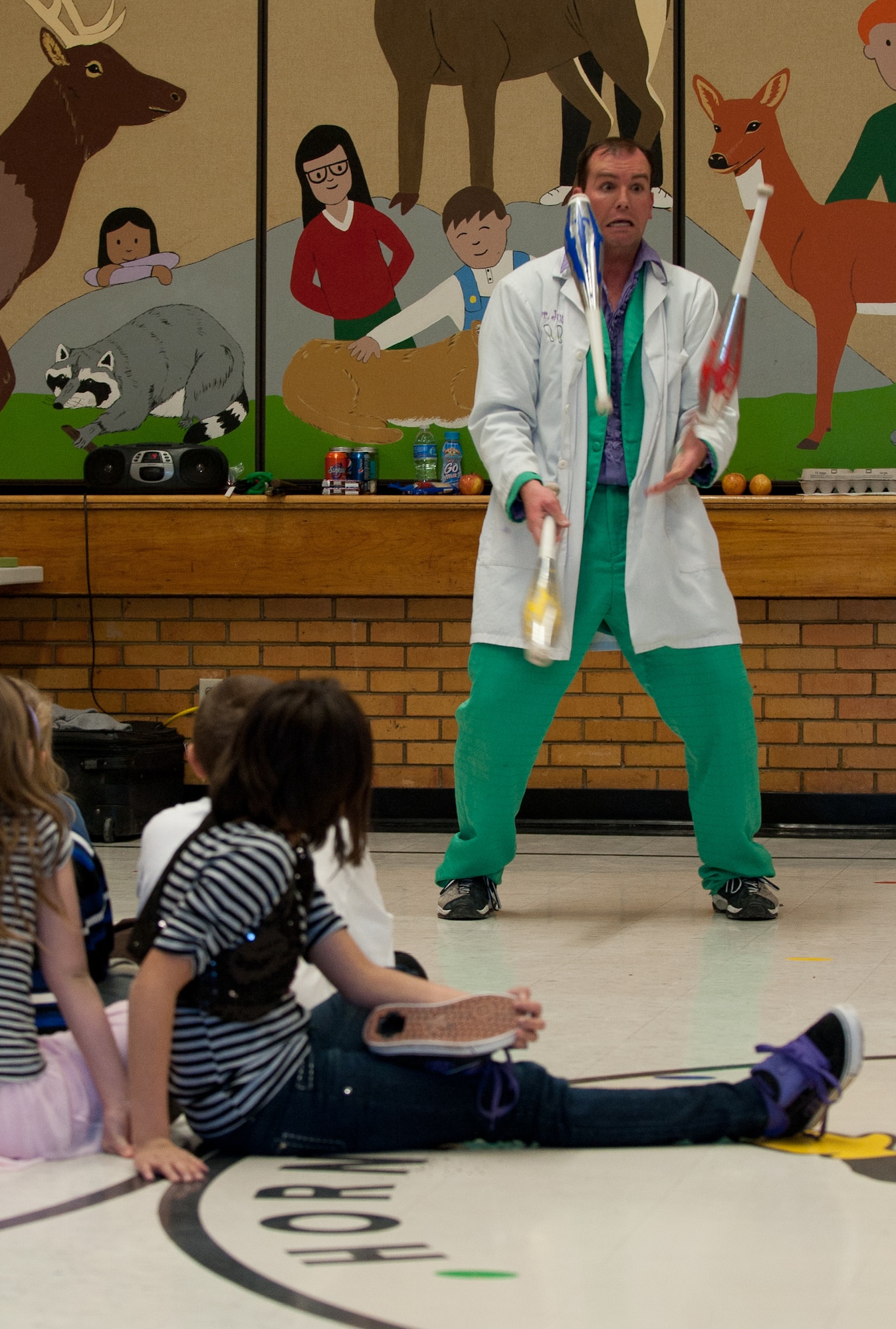 Capt. Bradley Harrelson, 28th Medical Operations Squadron dentist, also known as Dr. Juggles, demonstrates the importance of “juggling” various oral care techniques to the children of Horace Mann Elementary School in Rapid City, S.D., Feb. 9, 2012. Harrelson performed at schools in the Rapid City area for National Children’s Dental Health Month in hopes of inspiring children to pursue excellent oral hygiene. (U.S. Air Force photo by Airman 1st Class Kate Thornton/Released)