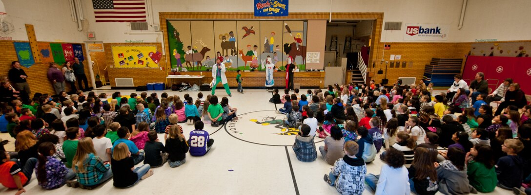 Capt. Bradley Harrelson, also known as Dr. Juggles, visited Horace Mann Elementary School with Staff Sgt. Kristen Randall, acting as Sparkle the toothbrush and Senior Airman Francis Morales, acting as Tubey the toothpaste, in Rapid City, S.D., Feb. 9, 2012. Harrelson and his staff, assigned to the 28th Medical Operations Squadron, performed at several elementary schools in the area educating children on the importance of oral health. (U.S. Air Force photo by Airman 1st Class Kate Thornton/Released)
