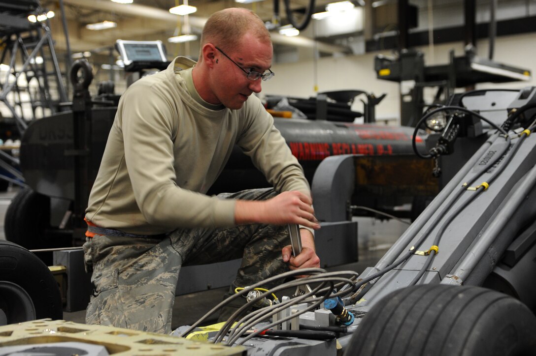 Staff Sgt. Lee Motz, 28th Maintenance Squadron aerospace ground equipment mechanic, adjusts the manipulator head on a bomb lift during scheduled maintenance at Ellsworth Air Force Base, S.D., Feb. 9, 2012. Bomb lifts are inspected every six months to ensure reliability as they continually load ordinance into B-1Bs with maximum efficiency. (U.S. Air Force photo by Airman 1st Class Zachary Hada/Released) 
