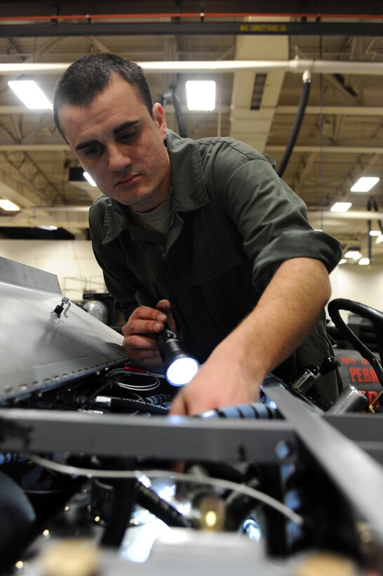Senior Airman James Strong, 28th Maintenance Squadron aerospace ground equipment mechanic, inspects a munitions handling unit’s hoses for leaks during scheduled maintenance at Ellsworth Air Force Base, S.D., Feb. 9, 2012. Airman Strong has been in the Air Force for three and a half years and is originally from Tampa, Fla. (U.S. Air Force photo by Airman 1st Class Zachary Hada/Released)