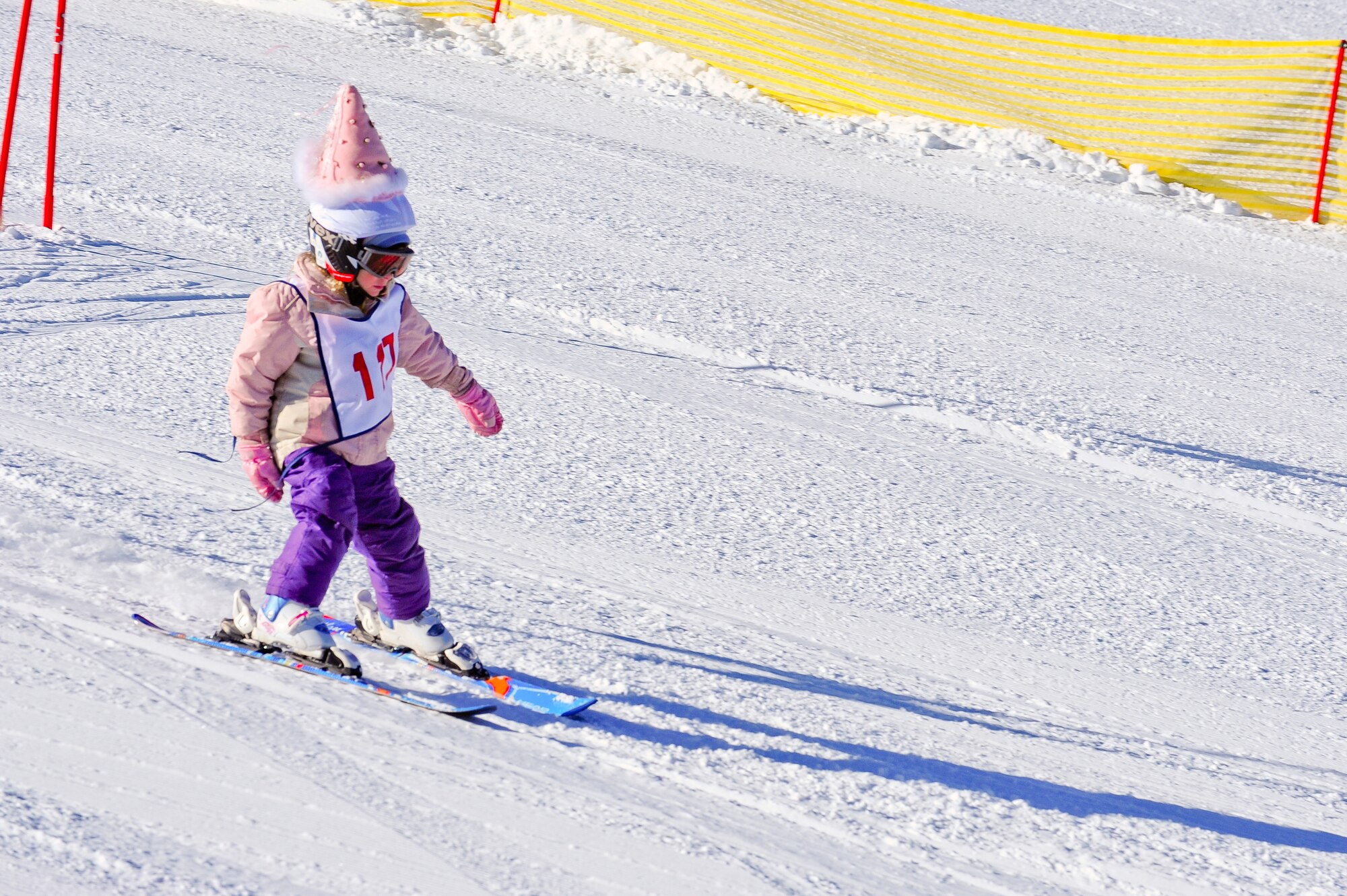 Aspen Haase, 5 years old, daughter of 310th Space Wing member Maj. Aaron Haase, Judge Advocate, competes in a ski race during SnoFest at Keystone, Colo. on January 28. Aspen won a bronze medal in the 3-8 age categorie. SnoFest is an annual winter event that features skiing, snowboarding, lodging, parties, giveaways, races, non skiing events and much more, all at discounted prices for the military community (including active duty, DoD civilians, family members and retirees). The event is put on by the USAF Academy Colo., Peterson AFB Colo., F.E. Warren AFB Wyo., HQ Air Force Space Command, Schriever AFB Colo., Buckley AFB Colo. and Ft. Carson Colo. (U.S. Air Force photo/Tech. Sgt. Nicholas B. Ontiveros).