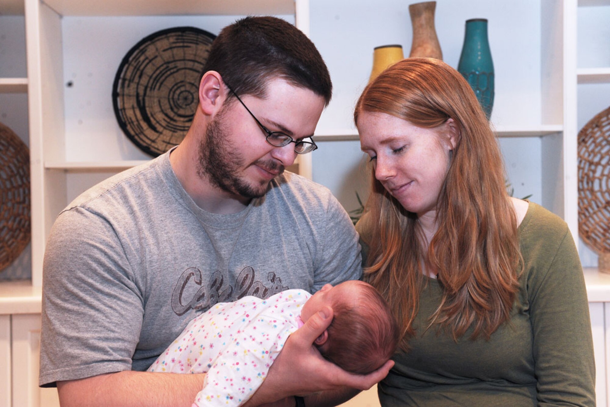 Senior Airman Joshua Crawford, his wife Rachael, and their newborn, Devi, sit inside the Alaska Fisher House Feb. 1 on Joint Base Elmendorf-Richardson. They were the first guests to stay at House since its opening Dec. 22. Joshua Crawford is a member of the 354th Communications Squadron, Eielson Air Force Base. (U.S. Air Force photo/Staff Sgt. Cynthia Spalding)