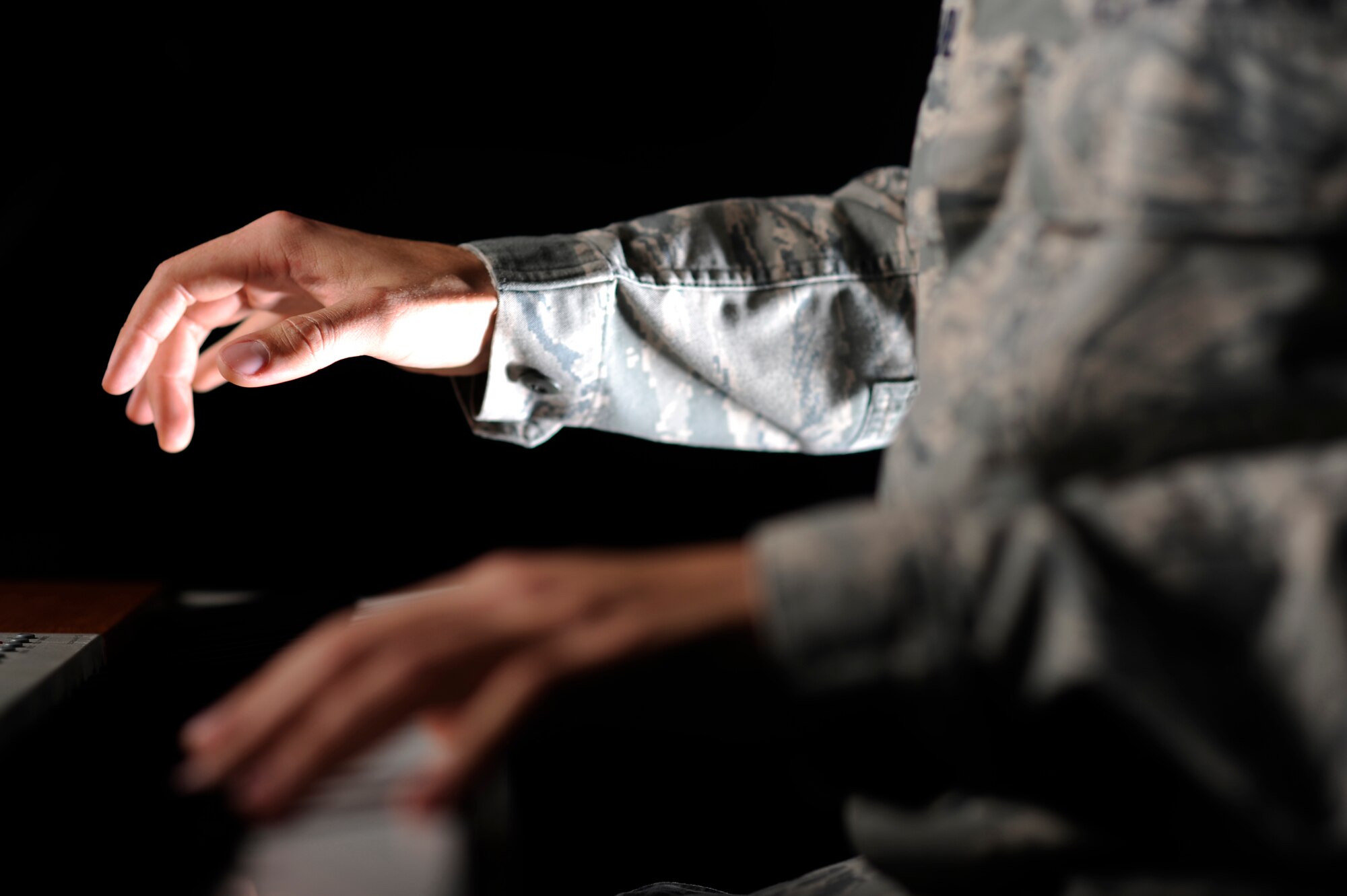 VANDENBERG AIR FORCE BASE, Calif. -- Airman 1st Class Alex Allred, 614th Air and Space Operations Center knowledge operator, illustrates his performance with  Tops in Blue here Monday, Feb. 13, 2012. Allred plays many instruments, but will be playing the piano in Tops in Blue. (U.S. Air Force illustrative photo/Staff Sgt. Andrew Satran) 

 