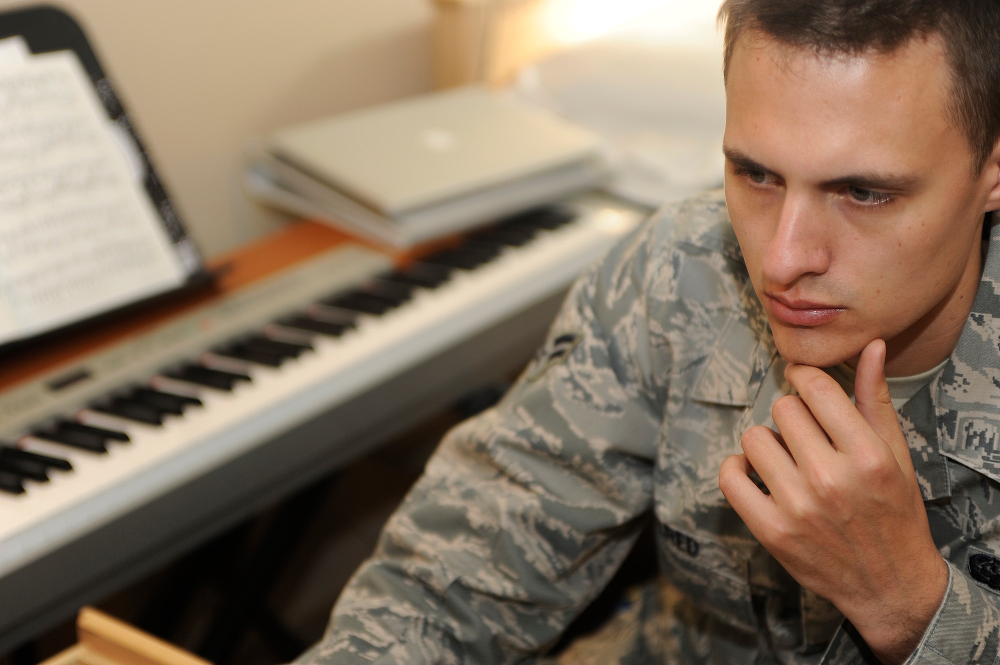 VANDENBERG AIR FORCE BASE, Calif. -- Airman 1st Class Alex Allred, 614th Air and Space Operations Center knowledge operator, works on a music compilation on his computer in his dormitory room Monday, Feb. 13, 2012. Allred was selected out of 80 Air Force members who applied to be a part of Tops in Blue, a music group that provides entertainment for military members worldwide. (U.S. Air Force photo/Staff Sgt. Andrew Satran) 

 