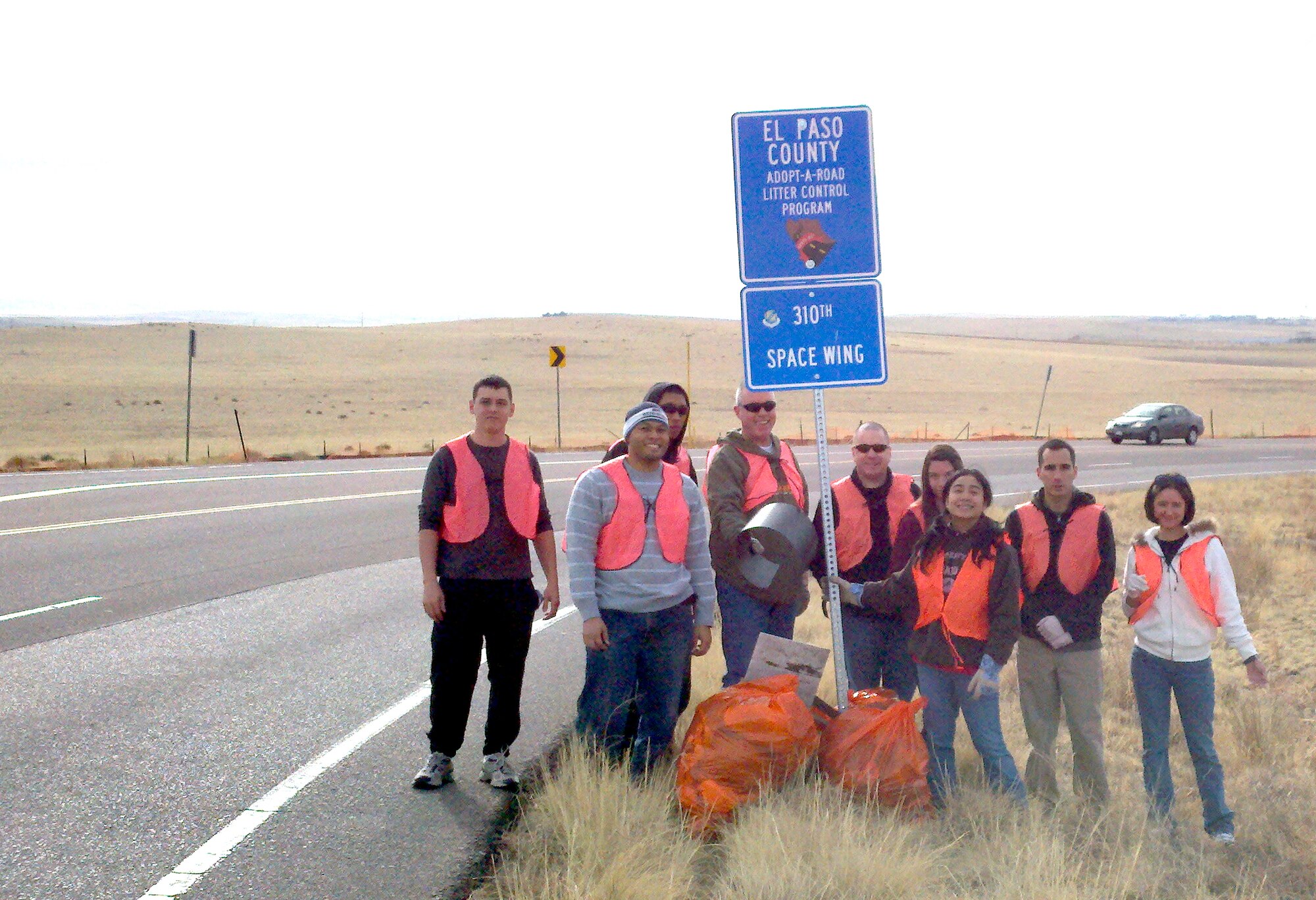 Members of the 310 Space Wing, family and friends donated their time by picking up debris and trash along Marksheffel road, a strip of road between U.S. Highway 24 and U.S. Highway 94 in Colorado Springs, on January 21. The wing has been a part of the "Adopt a Road" program for over three years. The purpose is to keep litter under control, help the environment and support the community. (U.S. Air Force photo/Senior Master Sgt. (ret.) Dave J. Andrus).