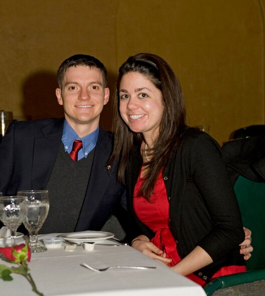 Capt. John Walker, 608th Air Operations Center, poses with his wife, Mary, during dinner at the Barksdale Club on Barksdale Air Force Base, La., Feb. 14. During the dinner, every female received a complimentary rose and every attendee received a complimentary glass of champagne. (U.S. Air Force photo/Airman 1st Class Benjamin Gonsier)(RELEASED)