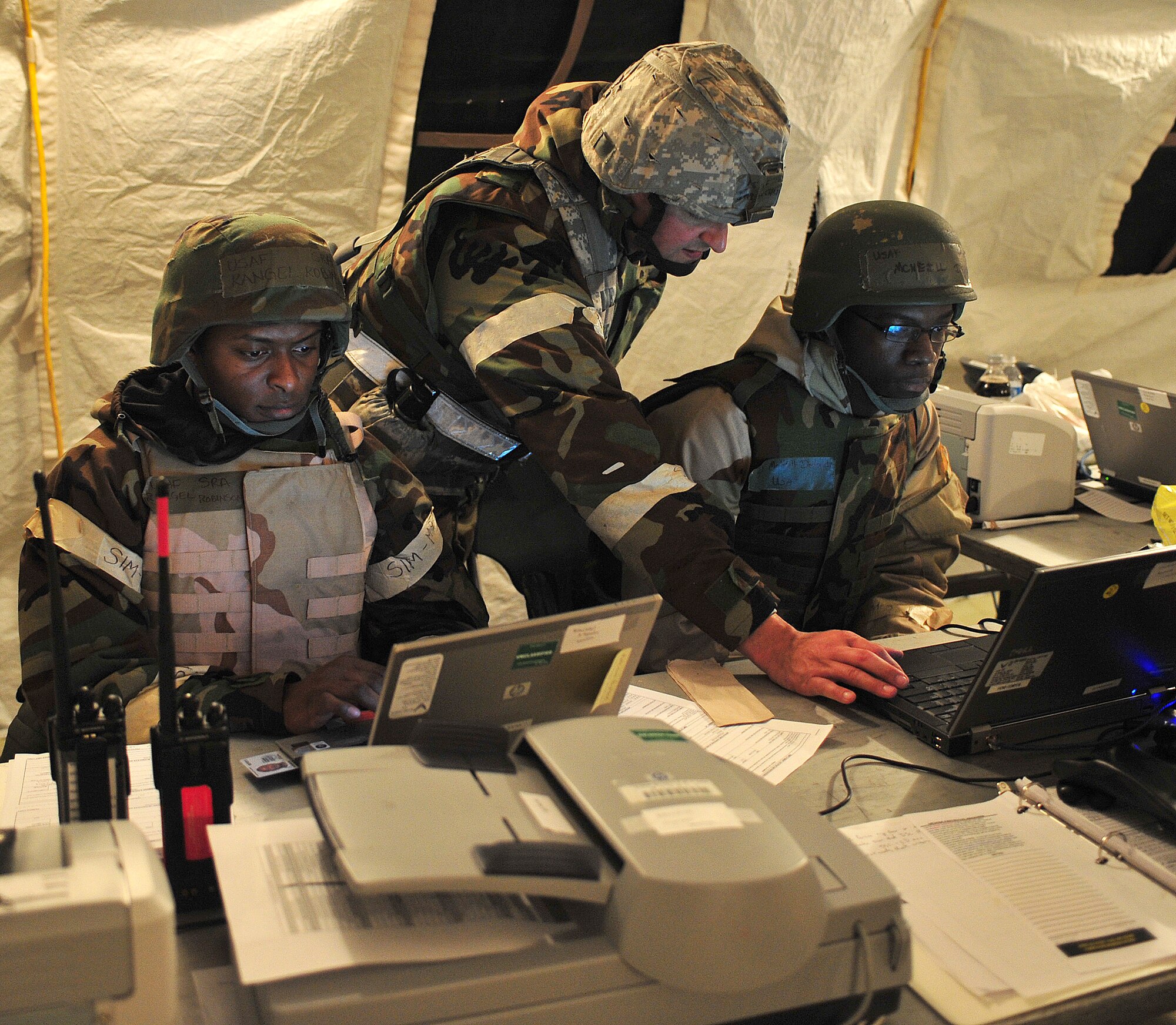 U.S. Air Force Airman 1st Class Rangel Robinson, left, Senior Airman DeVondre McNeill, right, 23d Force Support Squadron personnel support for contingency operations team member, and Master Sgt. Jason Chrisman, 23d FSS team chief, complete casualty messages and begin to forward them to the Air Force Personnel Center . The primary mission of PERSCO teams is to support the combatant commander by providing force accountability, casualty reporting and sustainment functions to assist in managing the deployed force. (U.S. Air Force photo by Staff Sgt. Stephanie Mancha/Released)
