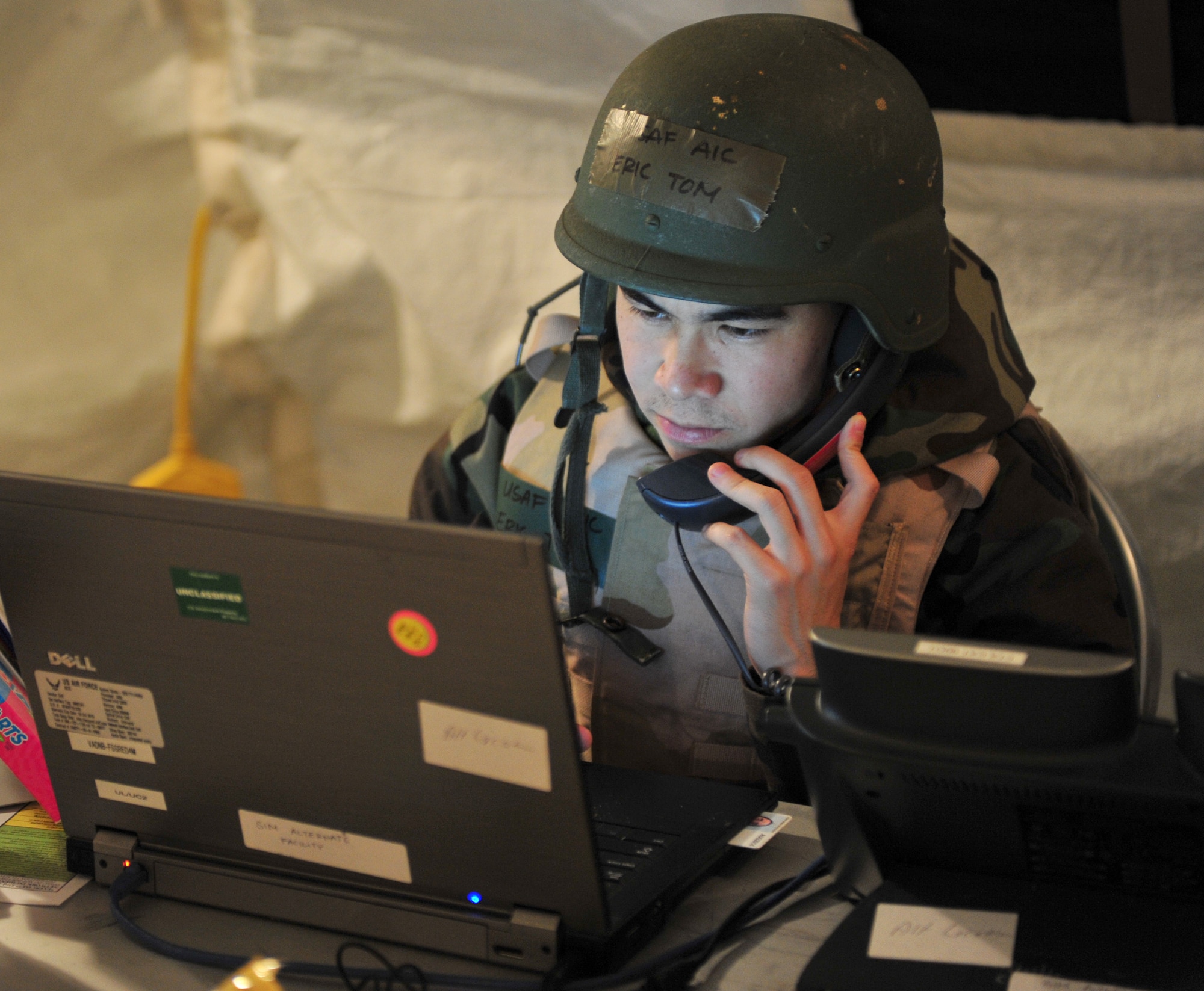 U.S. Air Force Airman 1st Class Eric Tom, 23d Force Support Squadron unit control center team member, reports information to the emergency operations center during a phase II operation readiness exercise at Moody Air Force Base, Ga., Feb. 15, 2012. UCCs are responsible for personnel accountability, emergency notification, recovery actions and to provide any support required by the EOC. (U.S. Air Force photo by Staff Sgt. Stephanie Mancha/Released)
