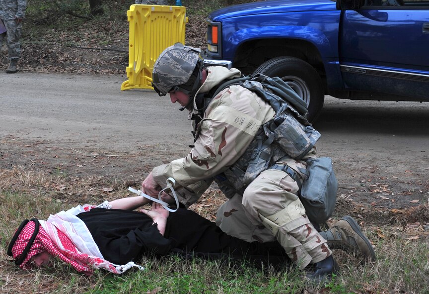 U.S. Air Force Staff Sgt. Jonathon Little, 23d Security Forces Squadron fire team leader, places handcuffs on a suspicious driver who was trying to gain access to the field training exercise site during a phase II operation readiness exercise at Moody Air Force Base, Ga., Feb. 15, 2012. Airmen from the 23d Wing are preparing for an operational readiness inspection being held this spring. (U.S. Air Force photo by Staff Sgt. Stephanie Mancha/Released)
