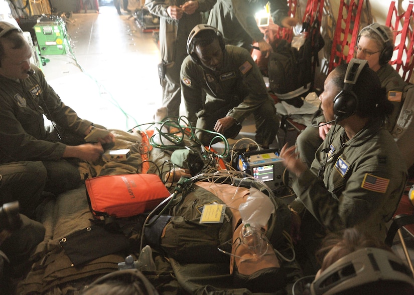 Members of the 459th Aeromedical Squadron treat a simulated patient during a training exercise aboard a KC-135 Stratotanker flying over the Carolinas Feb. 10. The squadron conducts the training about once a week in order to allow every member to maintain their required amount of in-flight hours. (U.S. Air Force photo/Airman Aaron Stout)