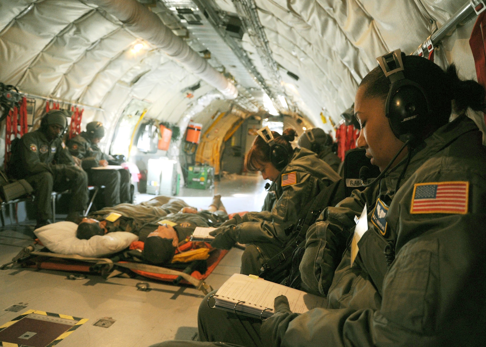 Capt. Meia Rabotaeu, 459th Aeromedical Squadron flight nurse, reviews her checklist during a training exercise aboard a KC-135 Stratotanker Feb. 10. The standard aeromedical crew consists of two flight nurses and three aeromedcial technicians. (U.S. Air Force photo/Airman Aaron Stout) 