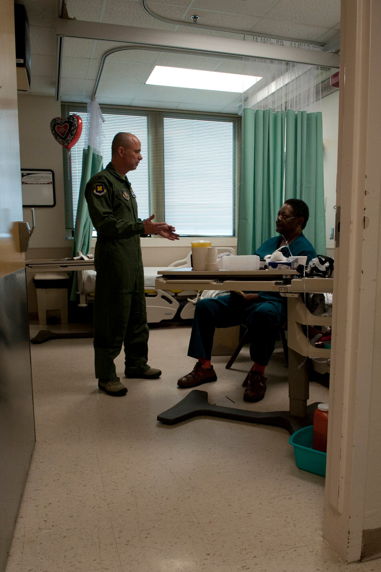 U.S. Air Force Col. Jonathan Ellis, 307th Bomb Wing commander, talks with a patient at the Overton Brooks Veterans Administration Medical Center, Shreveport, La., Feb. 15, 2012. Veterans of the United States armed forces may be eligible for a broad range of programs and services provided by the VA. (U.S. Air Force photo by Master Sgt. Greg Steele/Released)