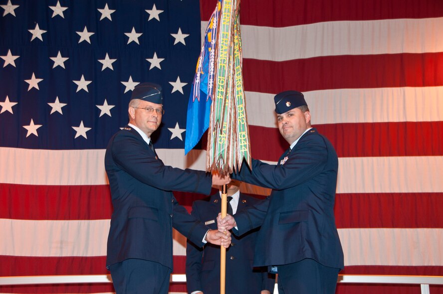 Col. Steven Parker, 340th Flying Training Group commander, (left) passes the guide-on to Lt. Col. Kevin Bullard as he accepts command of the 5th Flying Training Squadron in a ceremony at Vance Air Force Base, Okla., Feb. 10, 2012. (U.S. Air Force photo/Joe Wiles)