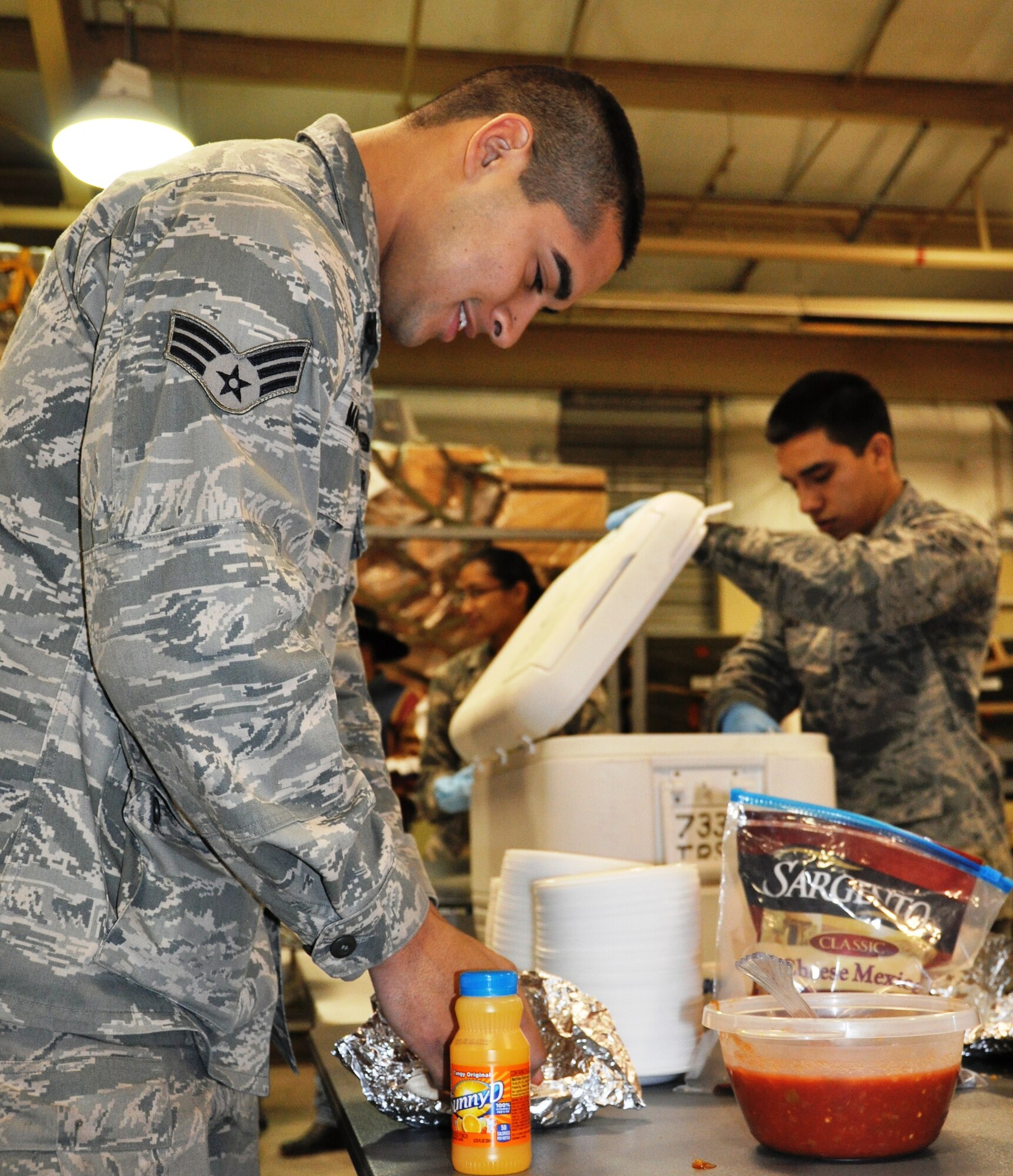 Senior Airman Eric Rodriguez prepares to upload some salsa onto his breakfast taco at the 433rd Airlift Wing's 12th Annual Cowboy Breakfast. The breakfast was held at the 733rd Cargo Load Training Facility and is timed to coincide with the San Antonio Stock Show & Rodeo.  Over 300 members and guests attended the event sponsored by the 433rd AW Top 3, Chief's Group and the Wing Advisory Council.  Attendees two-stepped to a disc jockey playing country music and dined on free breakfast tacos, orange juice, coffee, and biscuits and gravy. (U.S. Air Force Photo/ Tech. Sgt. Carlos Trevino)