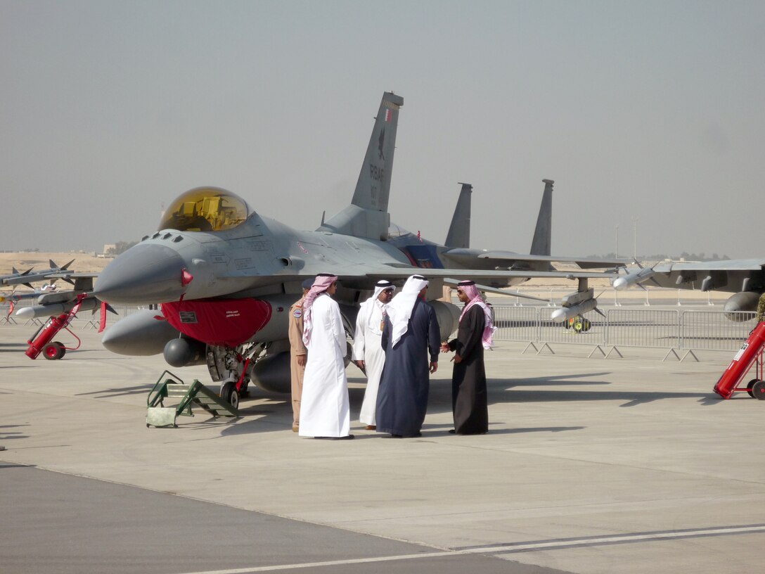 SAKHIR, Bahrain - VIP's tour past an F-16 during the Bahrain International Airshow on January 18, 2012. Airmen from the 106th Security Forces Squadron participated in this years show, meeting with the King of Bahrain and providing security for the visiting U.S. aircraft.