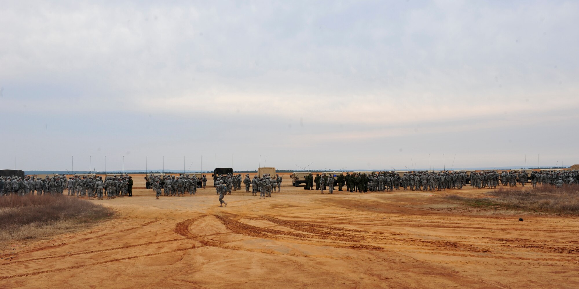 Approximately 1,000 U.S. and Canadian coalition forces survey the drop zone before their jump during Joint Operations Access Exercise 12-01 in Fort Bragg, N.C., Feb. 12, 2012. JOAX tests the ability of airborne units to jump into a hostile environment and conduct combat operations at night. The coaltion units included the U.S. Air Force 93rd Air Ground Operations Wing, U.S. Army's 82nd Airborne Division and Canadian 3rd Royal Canadian Regiment (U.S. Air Force photo/Staff Sgt. Stephanie Mancha)