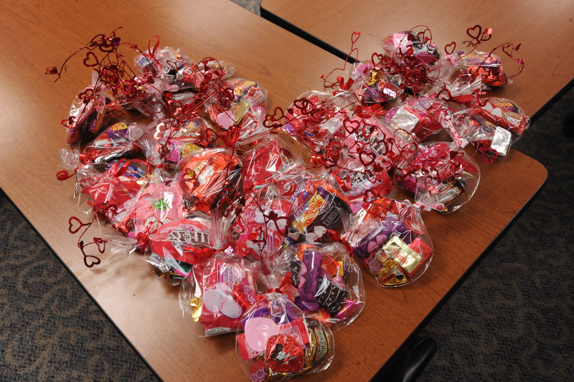 Valentine candy grams are arranged for display, and were later used as gifts to military members Feb. 14 on Grand Forks Air Force Base, N.D.  The gifts were part of Operation Cupid which helped raise $291 for Network 56.  Network 56 is a professional organization with the intentions of reaching out to the community and making a difference in themselves and others. (U.S. Air Force Photo by Airman 1st Class Xavier Navarro)