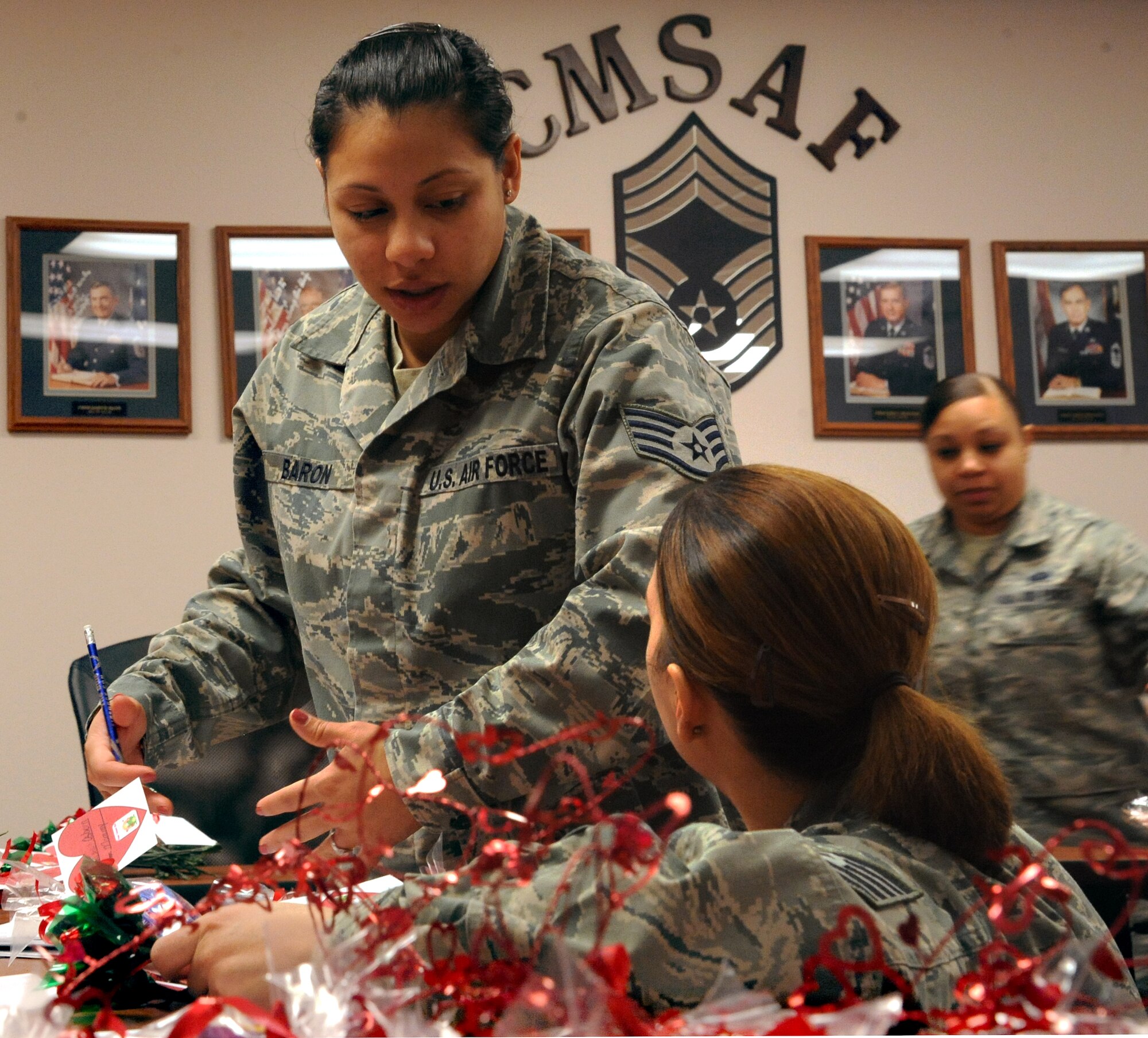 Staff Sgt. Nataly Baron, 319thForce Support Squadron, organizes the orders of valentine candy grams at the Airman Leadership School on Feb. 14 on Grand Forks Air Force Base, N.D.  The candy grams came from Operation Cupid which helped raise $291 for Network 56.  Network 56 is a professional organization with the intentions of reaching out to the community and making a difference in themselves and others. (U.S. Air Force Photo by Airman 1st Class Xavier Navarro) 