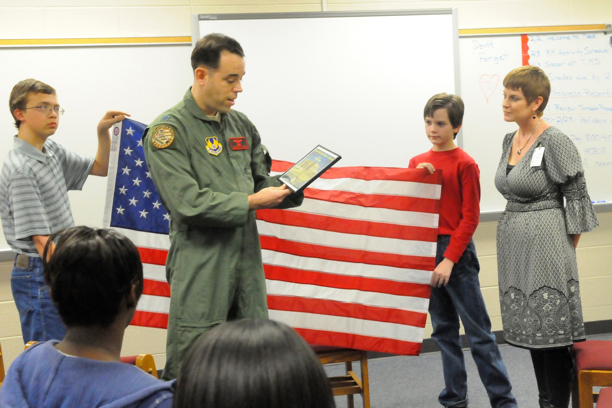 Lt. Col. Gene McFalls presents Cheri Murray the  U.S. Flag flown in her honor over USF-I Headquarters at Al Faw palace where Col. McFalls worked. U. S. Air Force photo by Sue Sapp