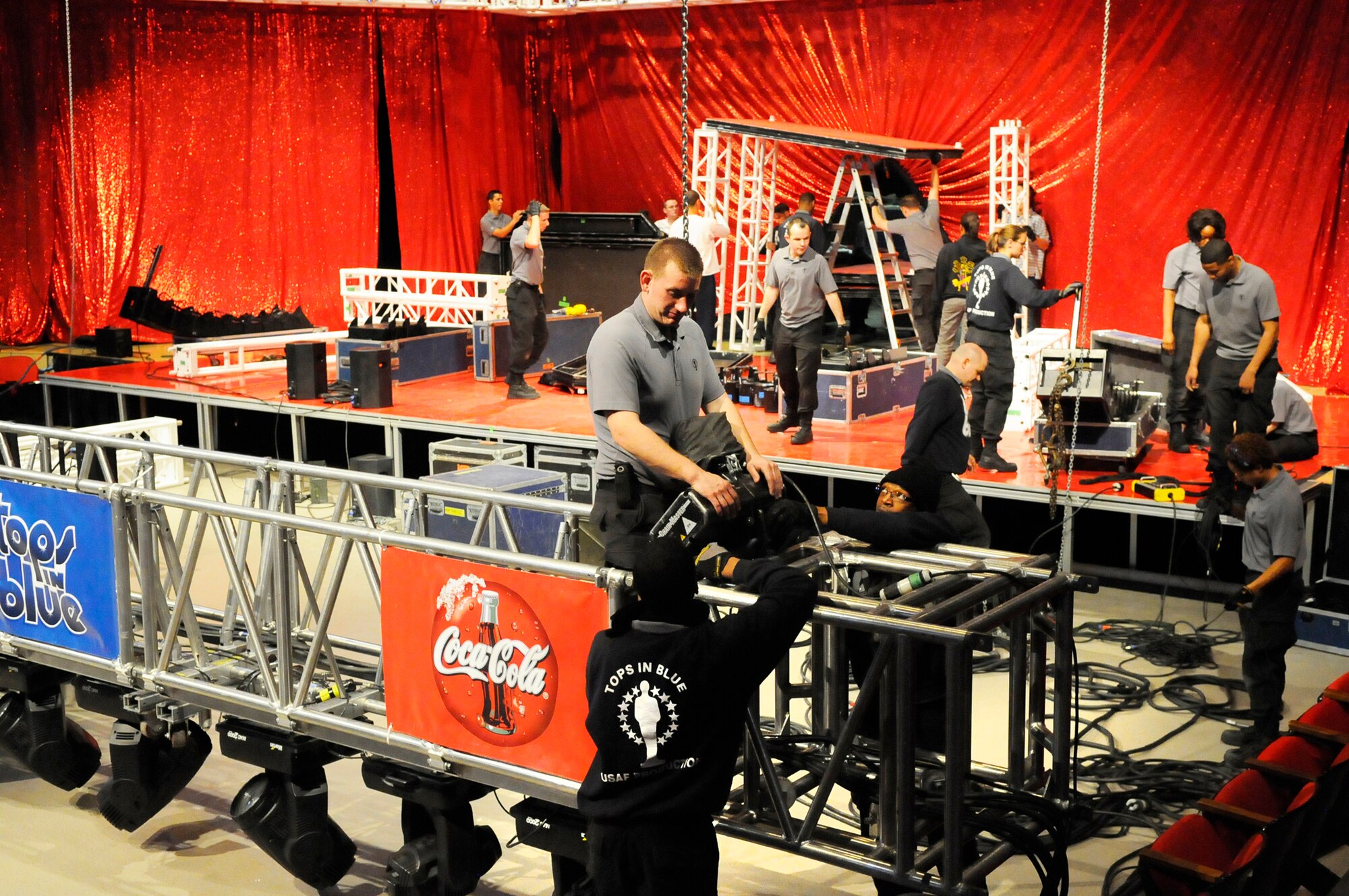 Tops in Blue members prepare the Civic Center for their performance Tuesday. The group sets up around 60,000 pounds of equipment for each performance then tears it down, repacks and loads up for their next venue. U. S. Air Force photo by Sue Sapp
