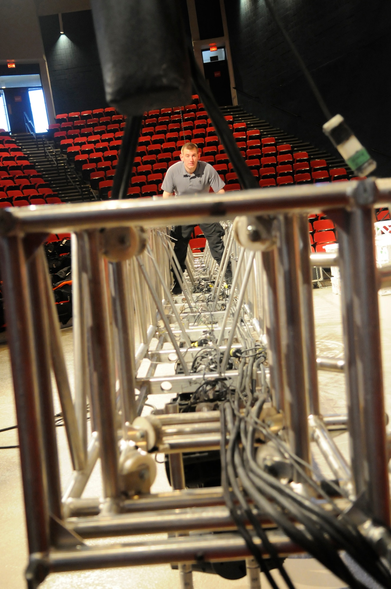 A1C Kegan Davis, Tops in Blue lighting director, sets up the front lighting truss for the performance. U. S. Air Force photo by Sue Sapp